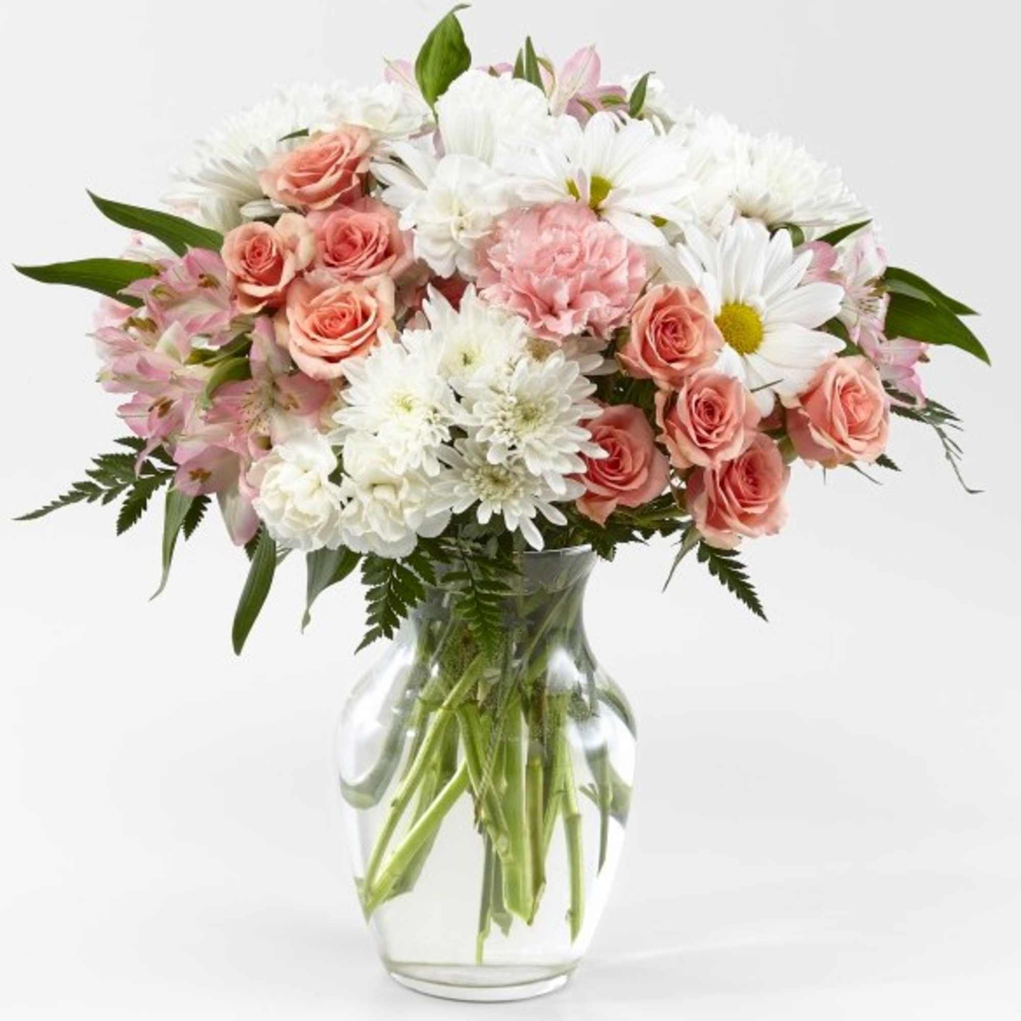 Pink roses and white daisies in a clear glass vase