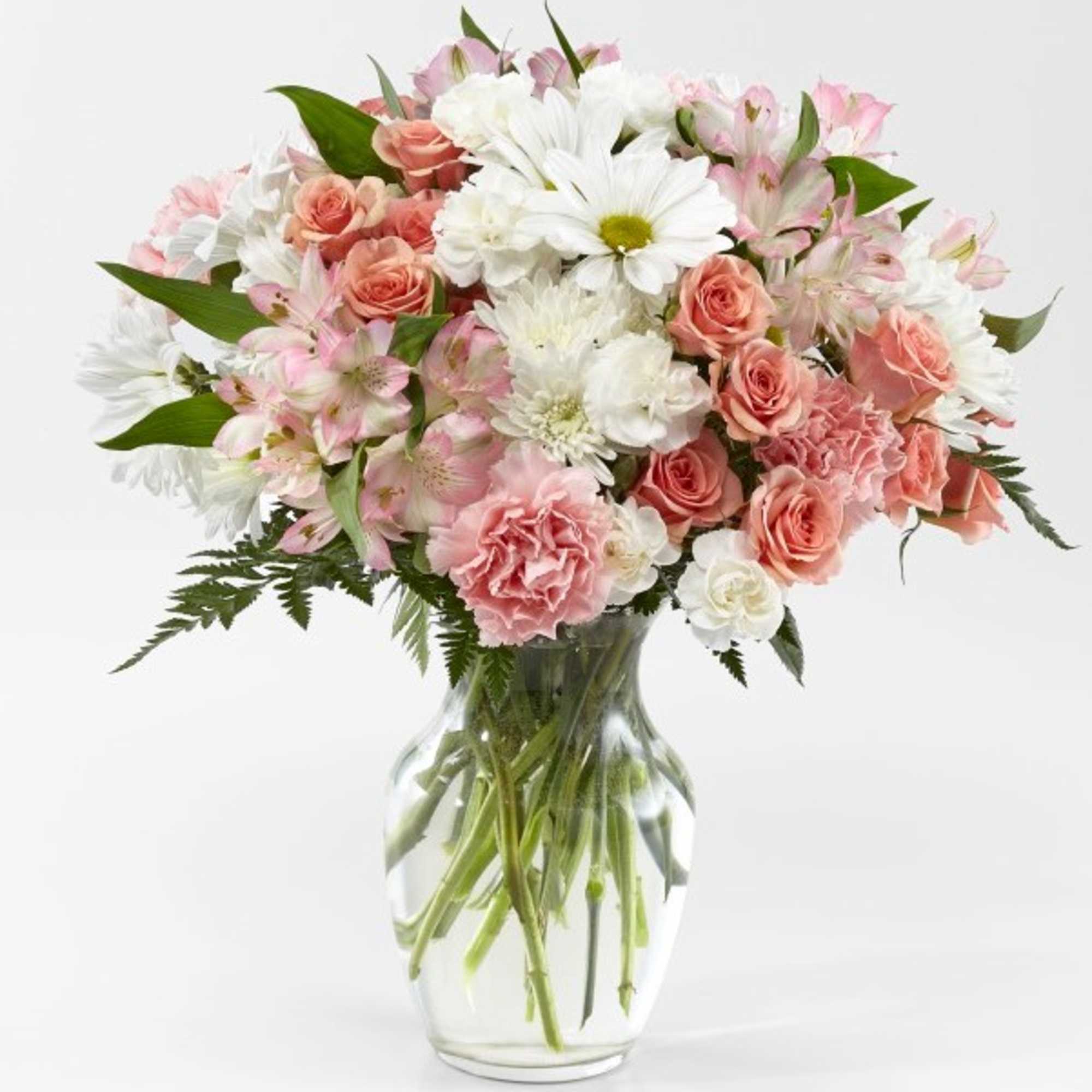 Pink and white mixed flower bouquet in a clear glass vase