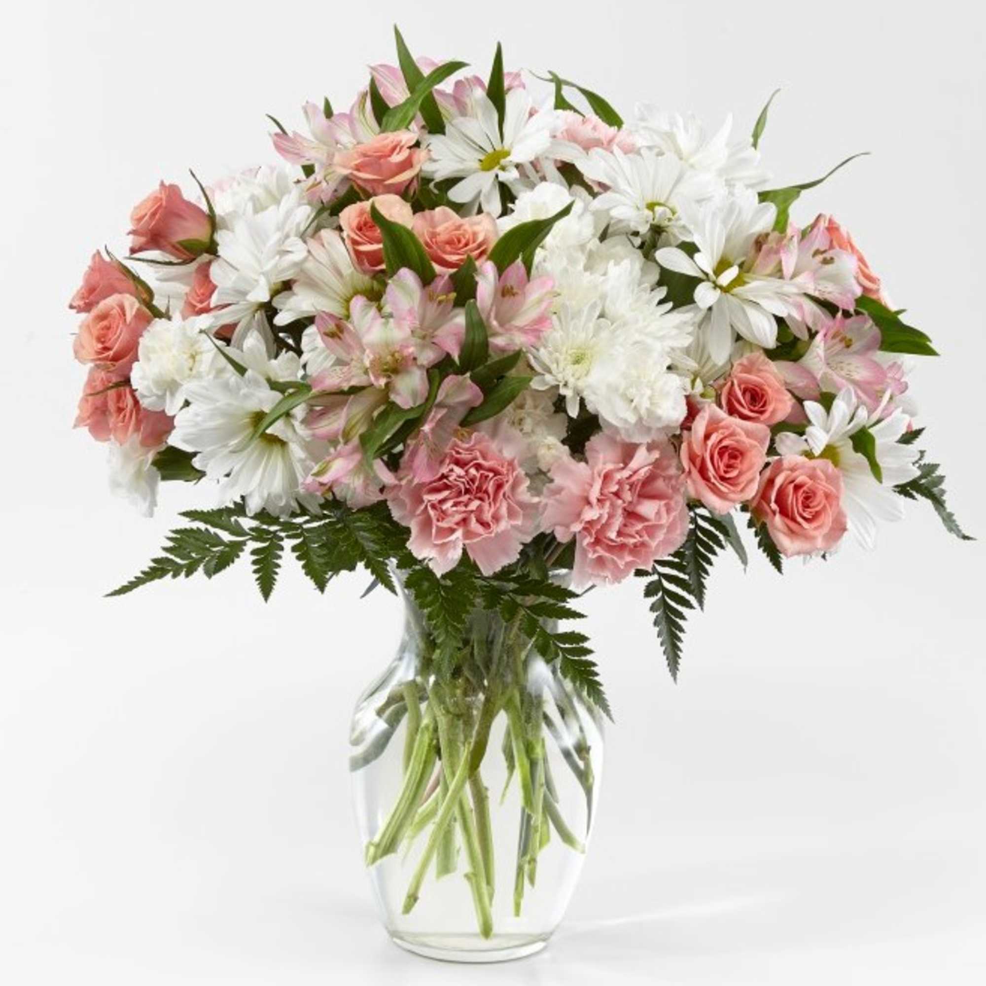 Pink and white mixed bouquet in a clear glass vase