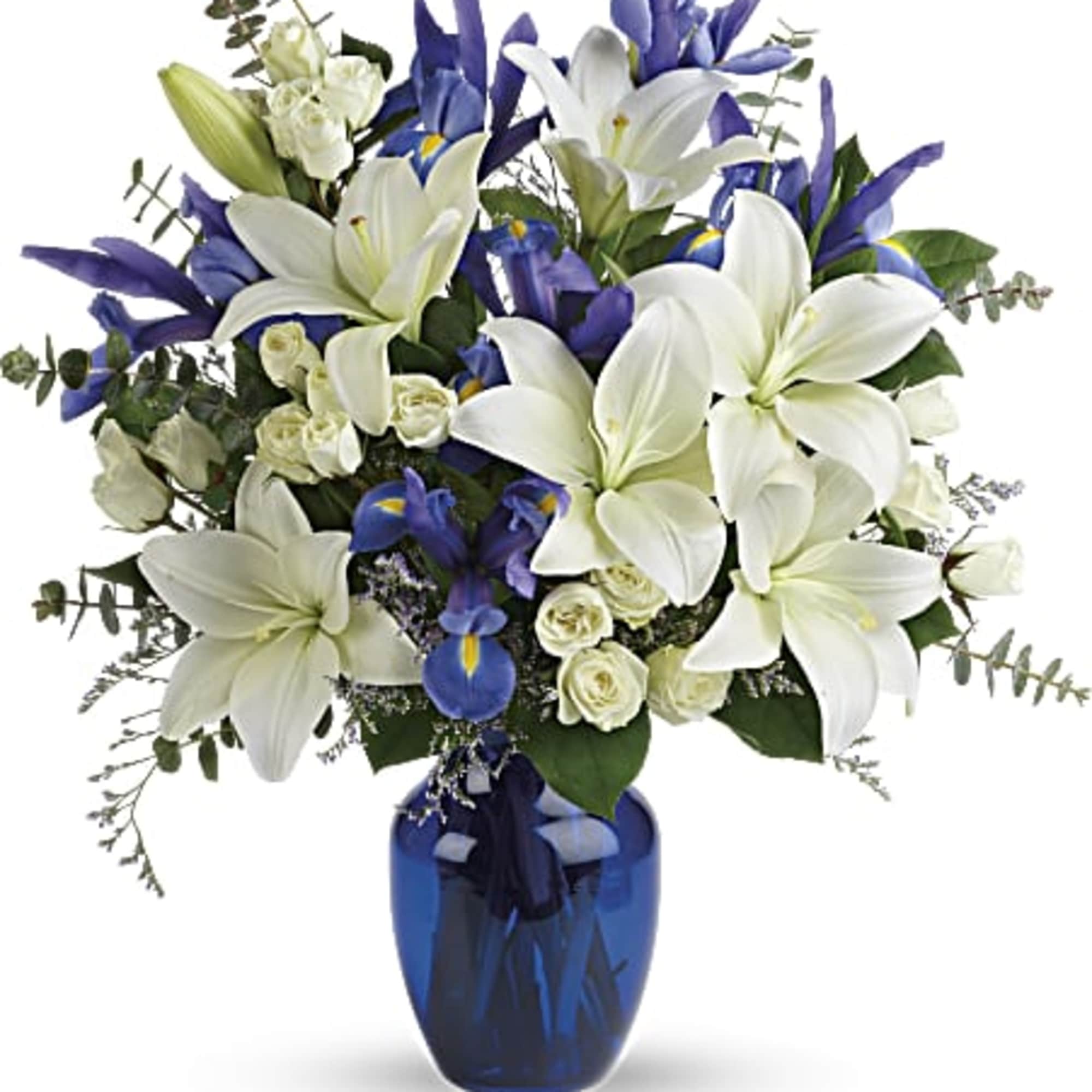 White lilies and blue irises in a blue glass vase