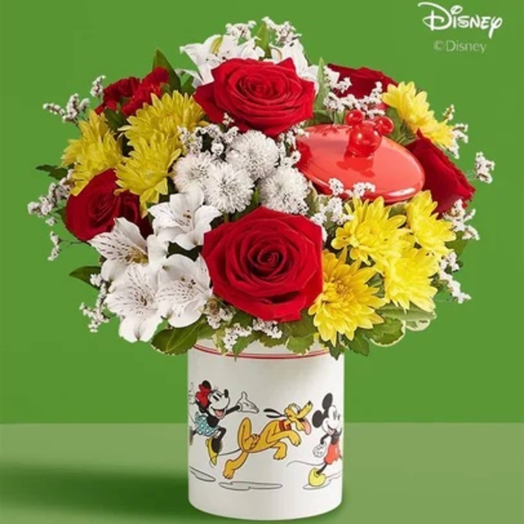 Bouquet of red roses, white lilies, and yellow daisies in a Disney-themed container