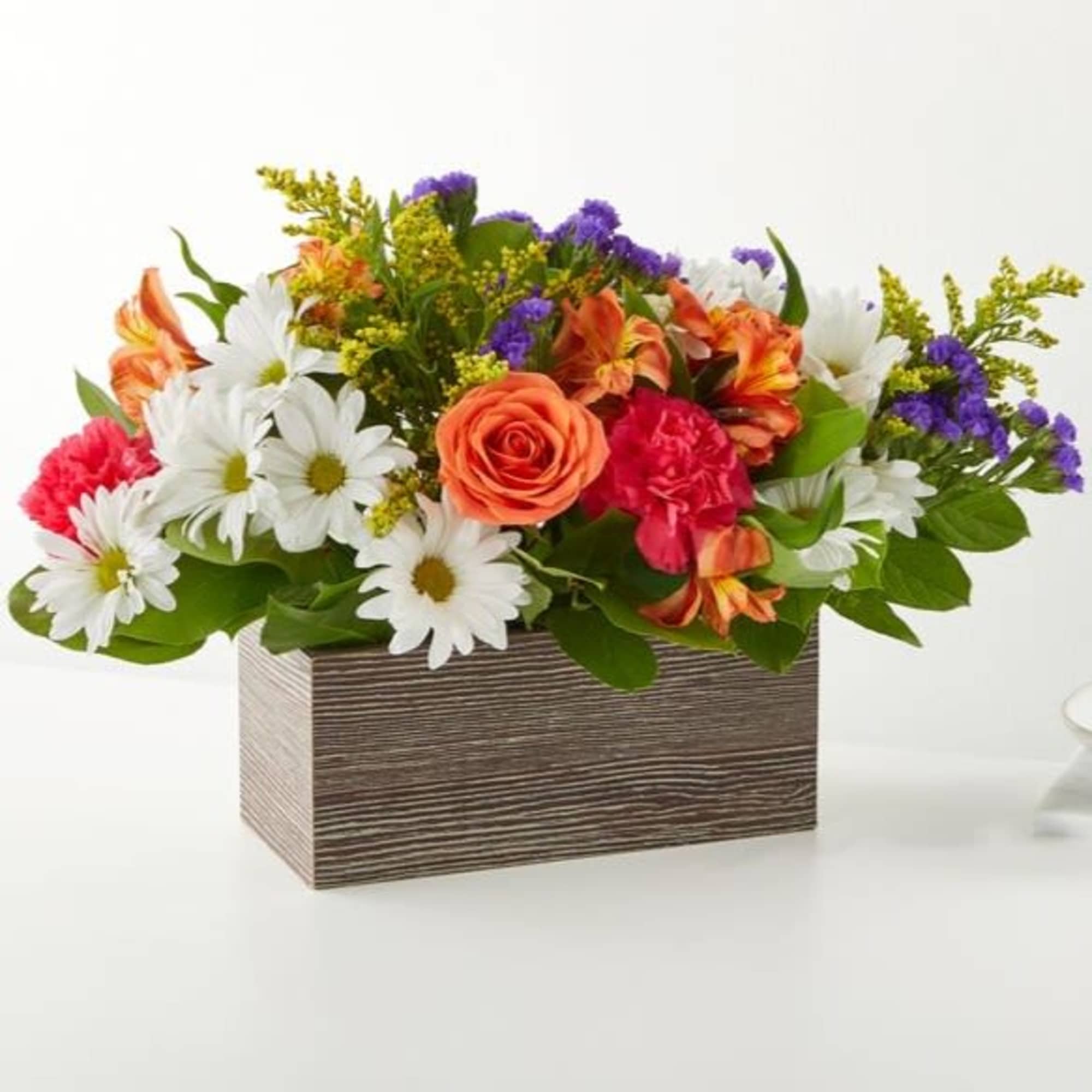 Mixed bouquet in a rectangular wooden box with white daisies and orange roses