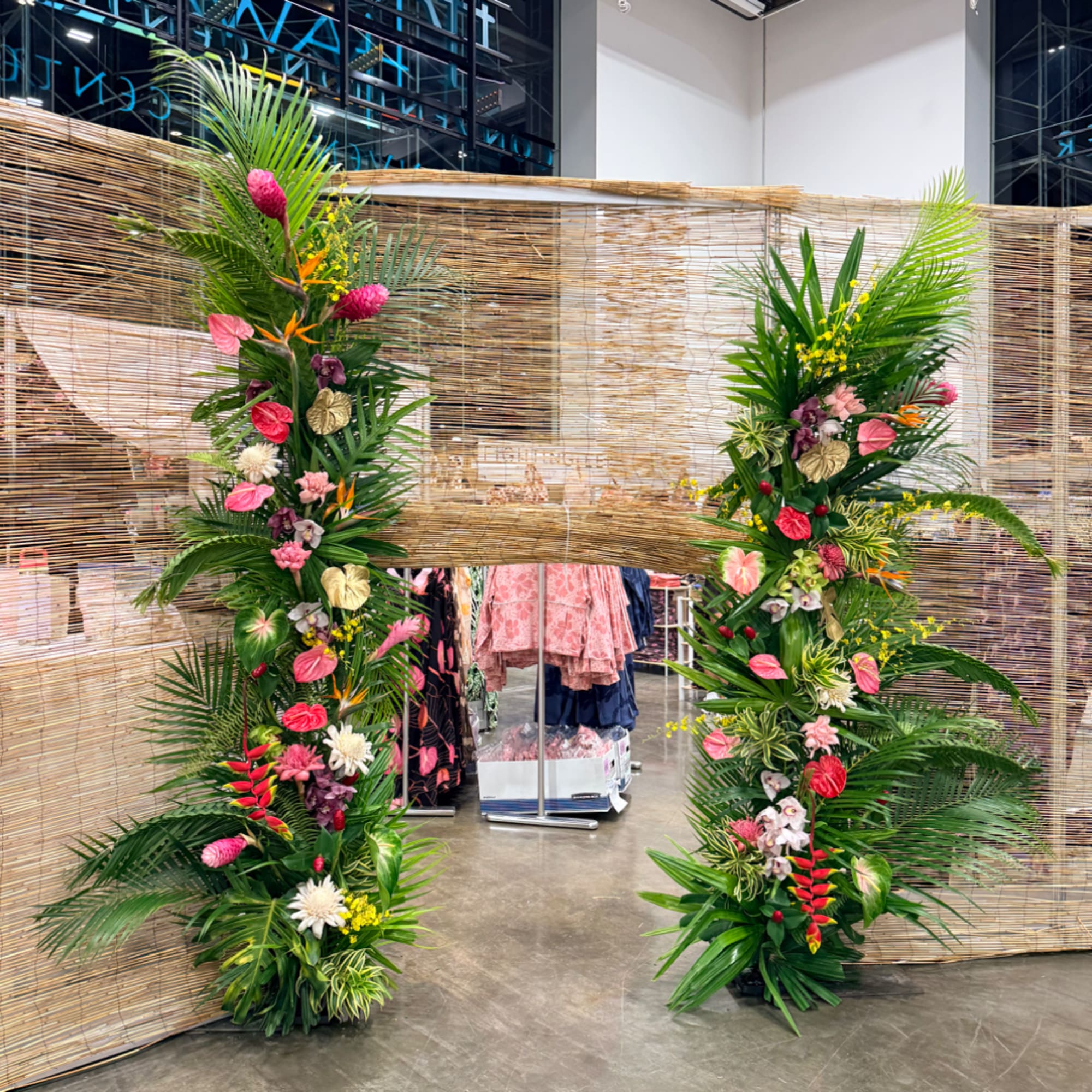 Two tall tropical floral columns framing a store entrance