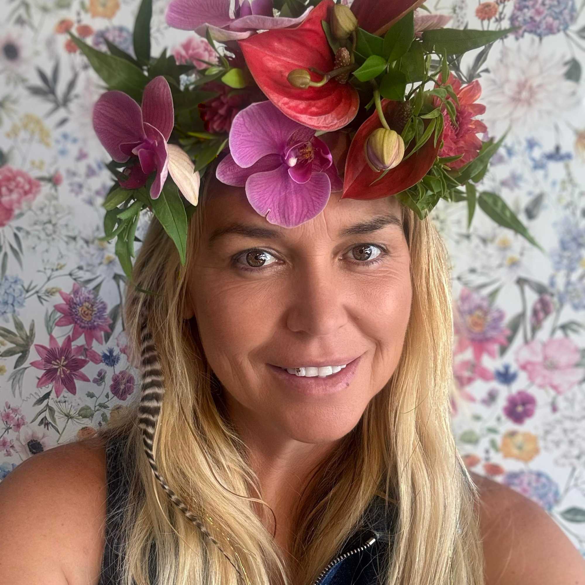Woman wearing a floral crown with orchids and anthuriums
