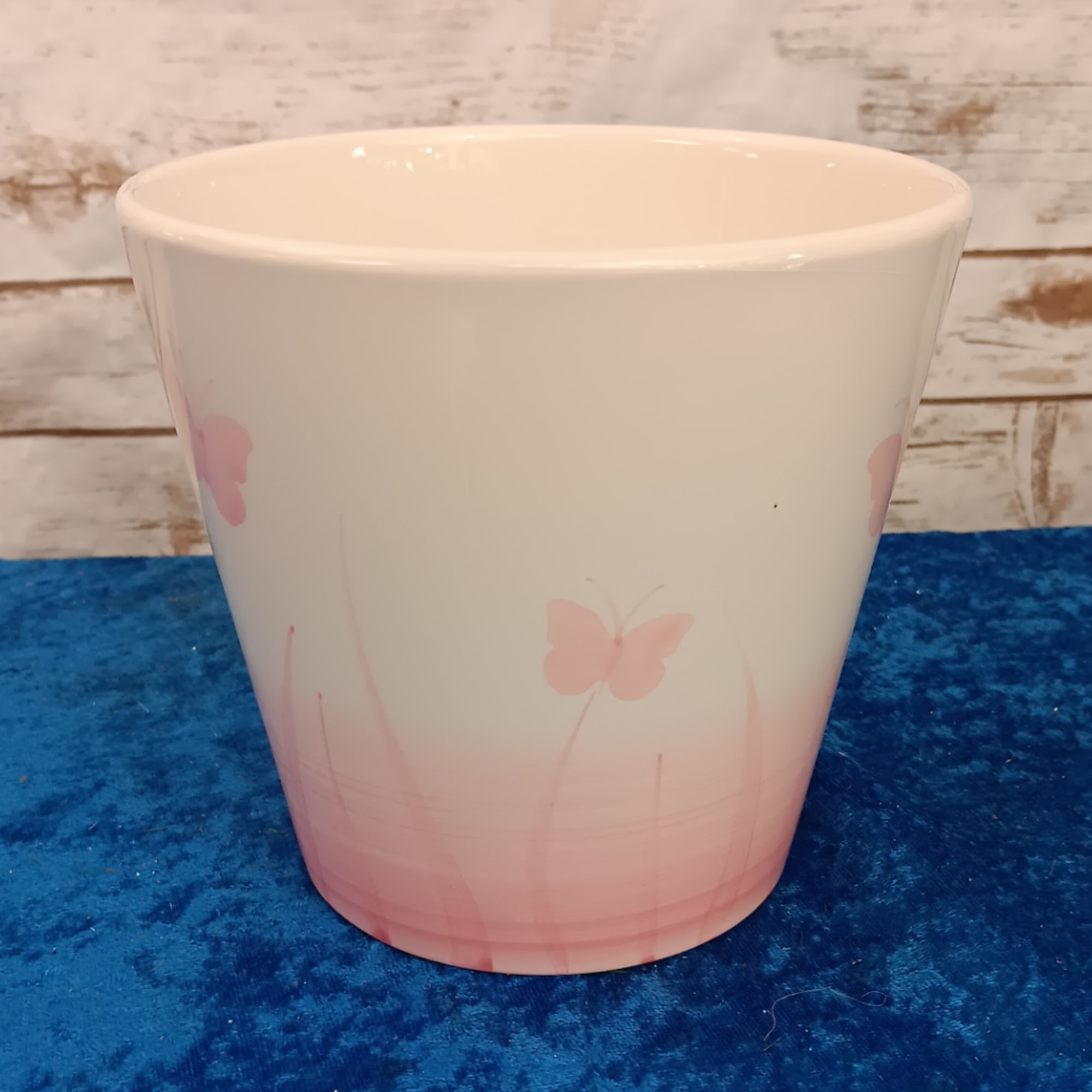 White ceramic planter with pink butterfly design