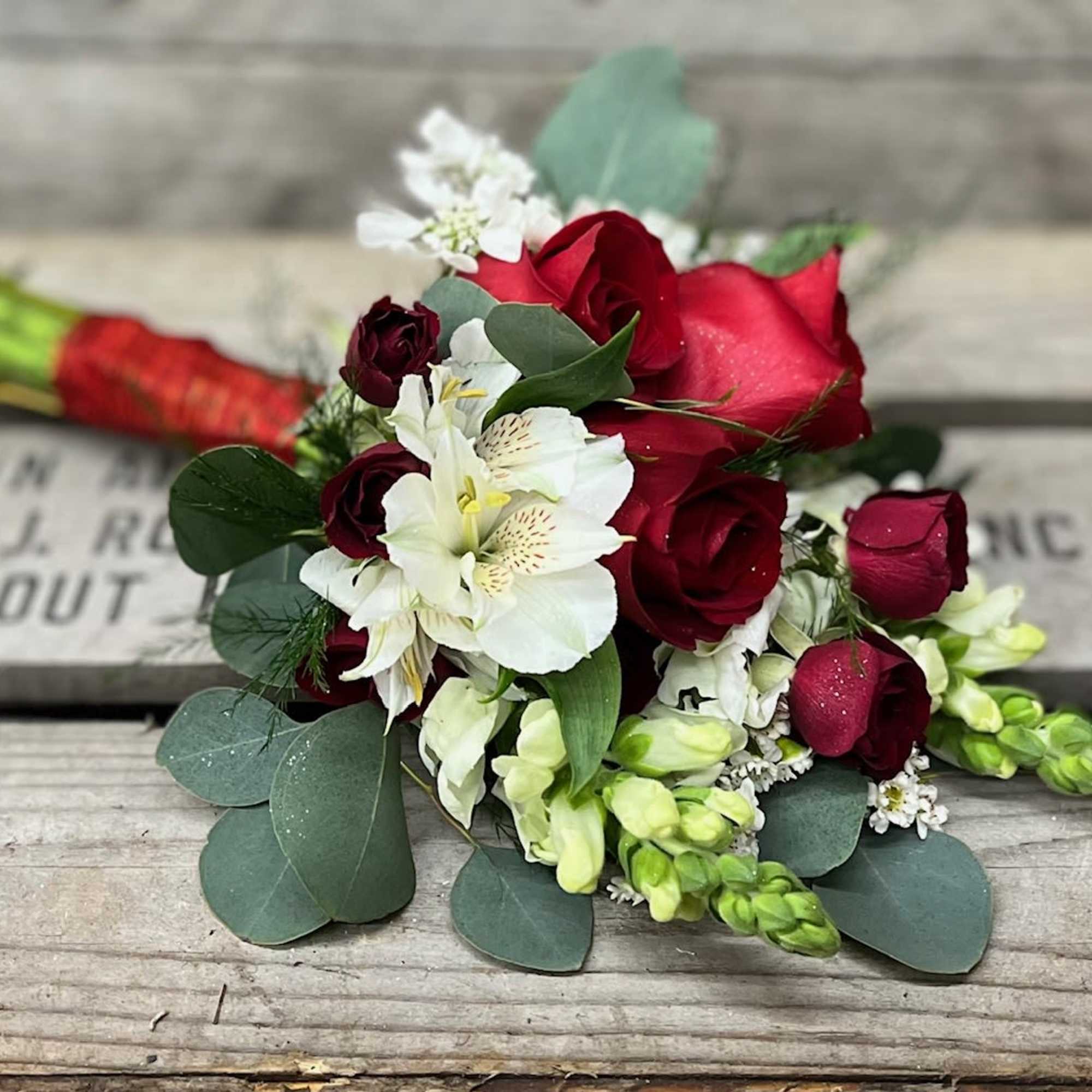 Bouquet of red roses and white flowers with eucalyptus