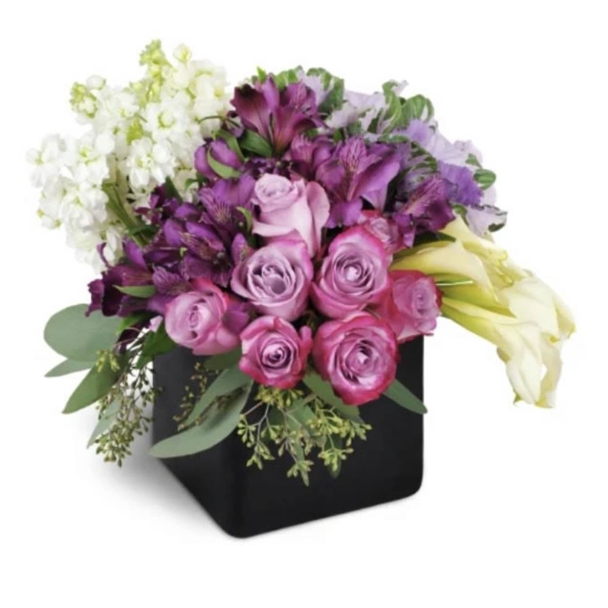 Pink and purple flowers arranged in a black square vase