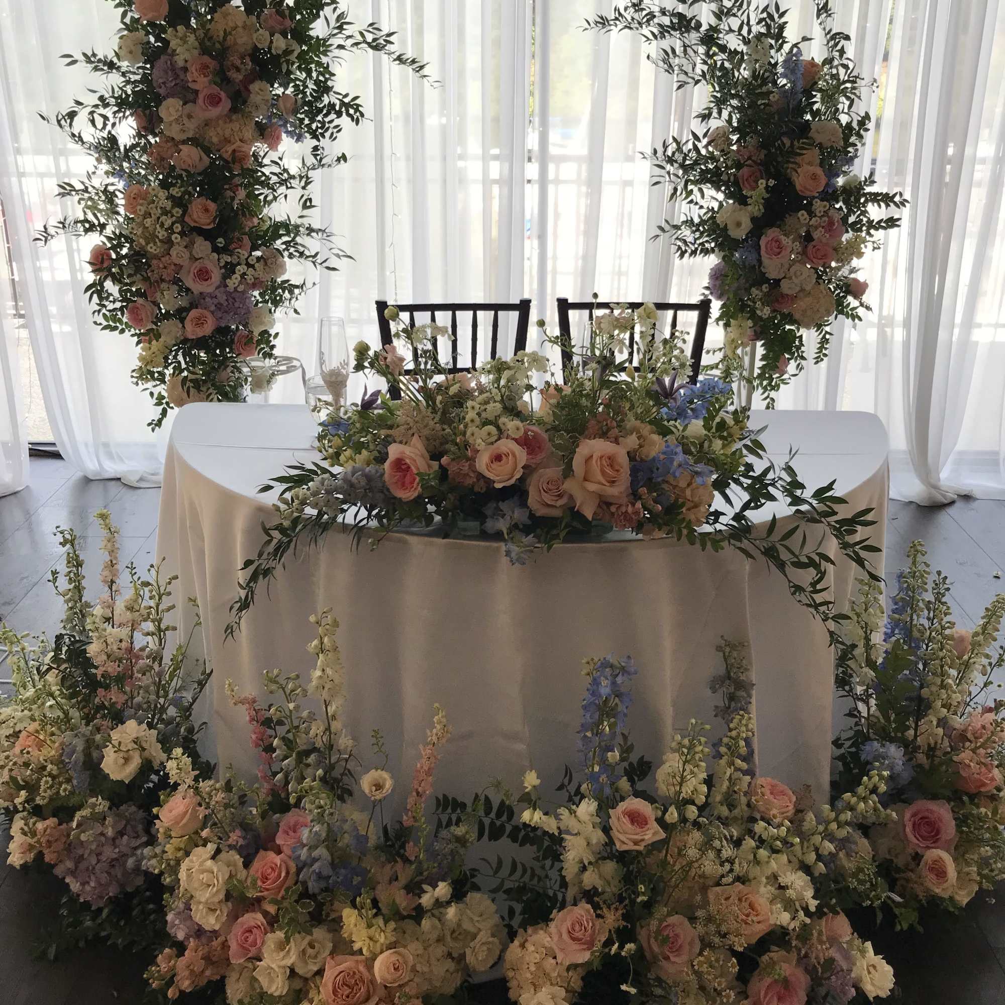 Large floral wedding table display with pink and white roses