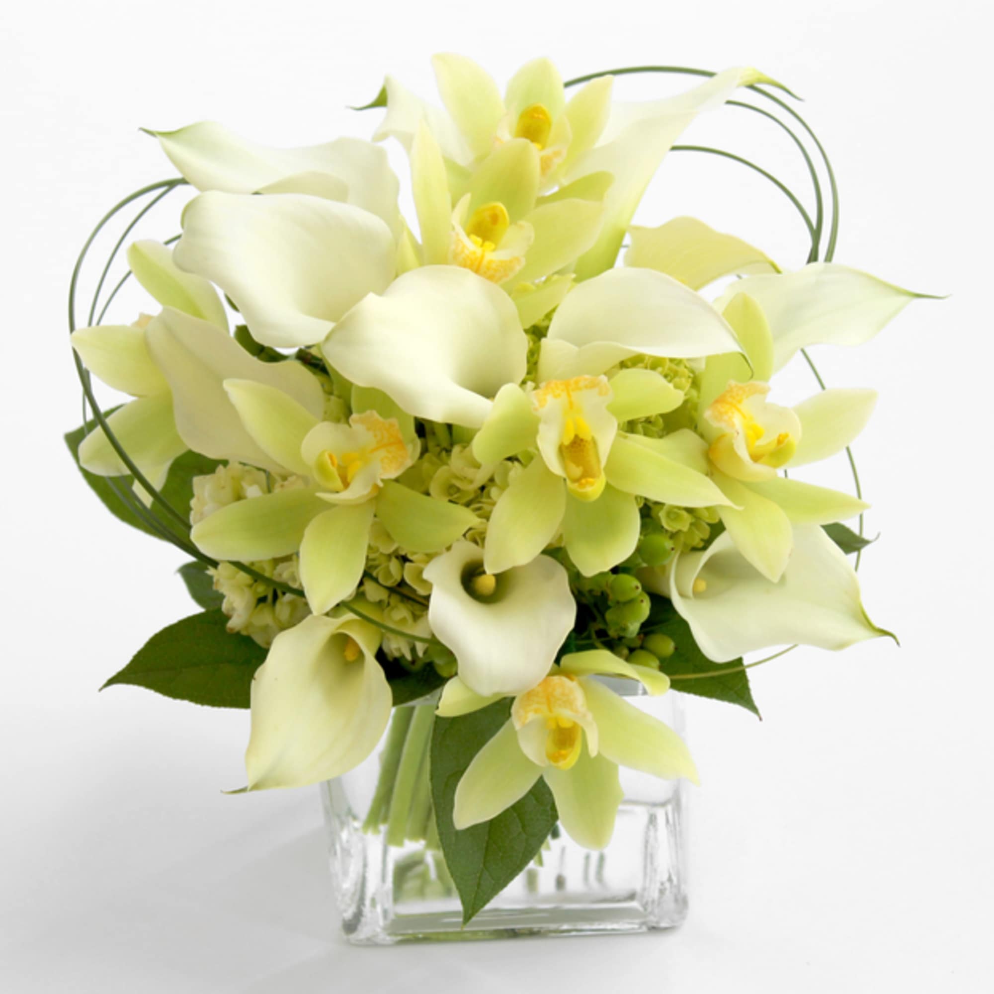 Pale yellow orchid bouquet in a clear square vase