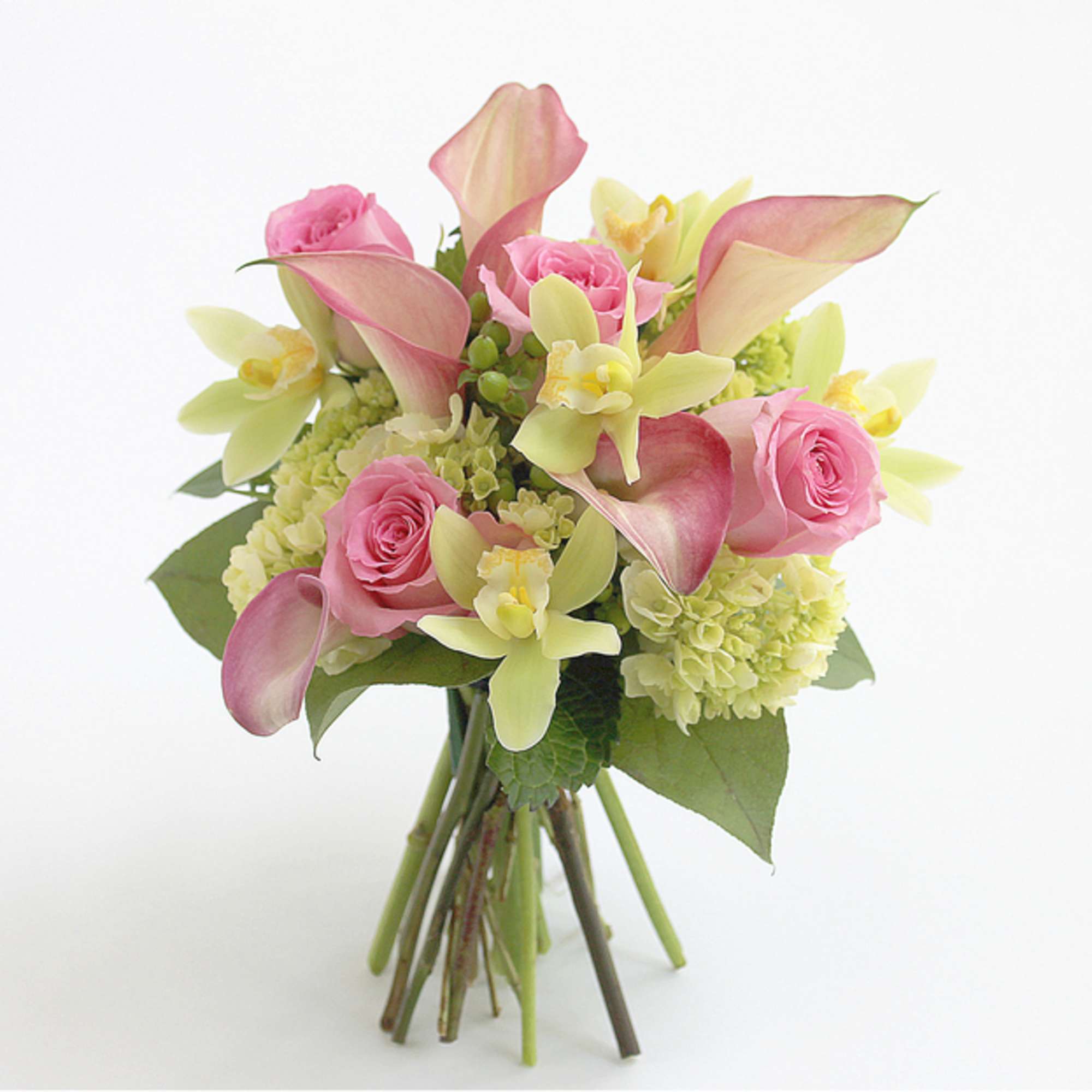 Pink roses and calla lilies arranged with pale green orchids