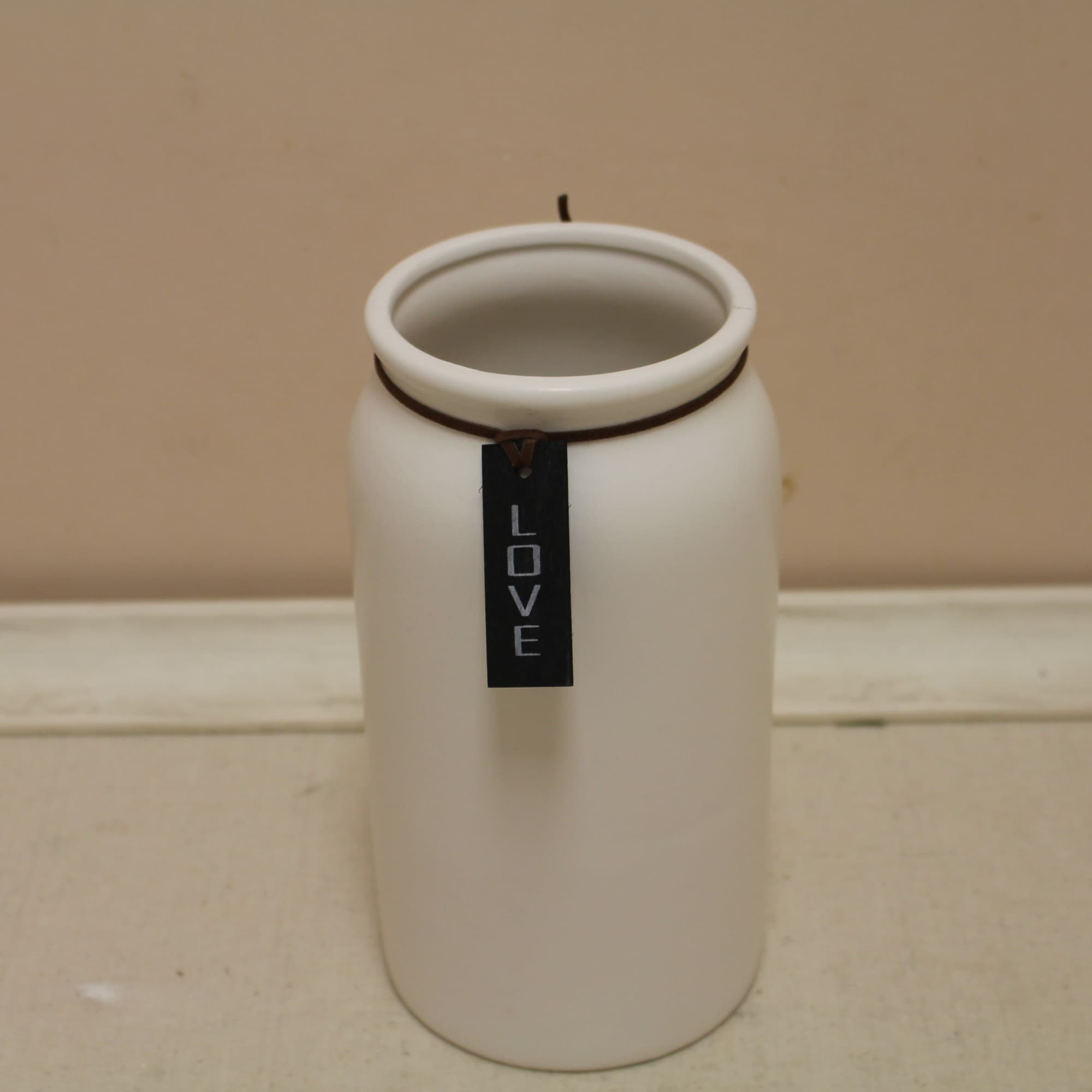 White ceramic candle holder with a hanging LOVE tag