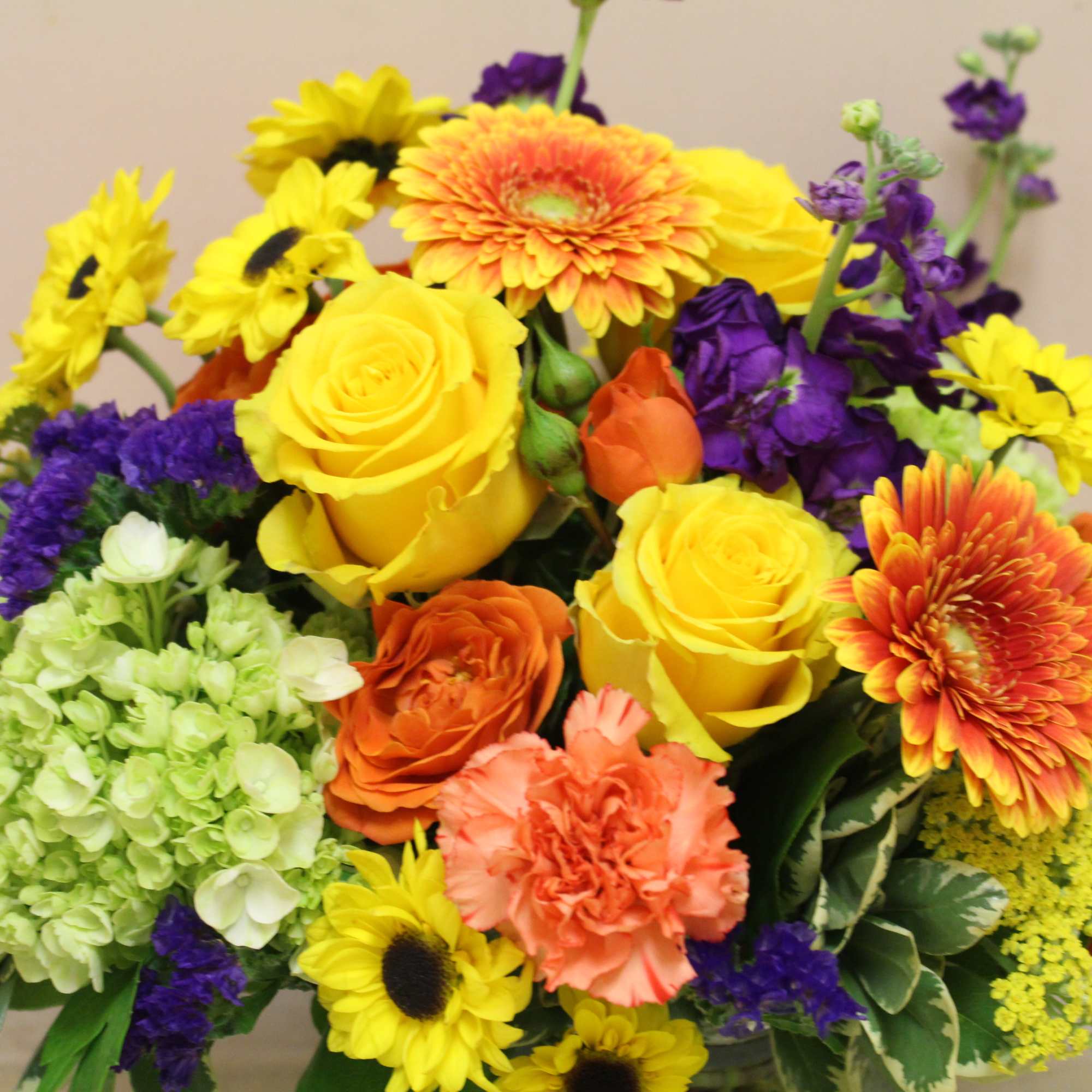 Bouquet of yellow, orange, purple, and green flowers