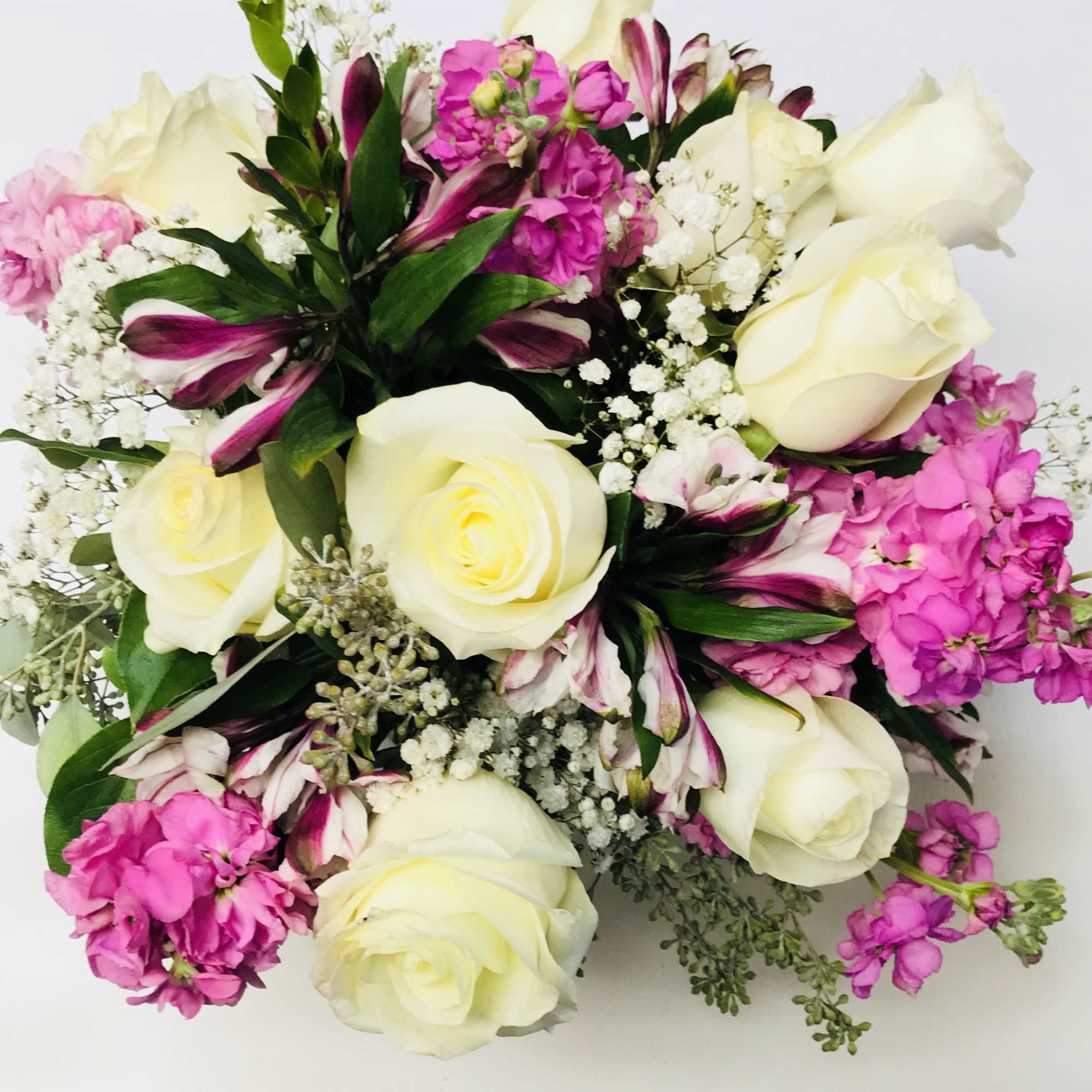 Bouquet of white roses, pink flowers, and striped lilies