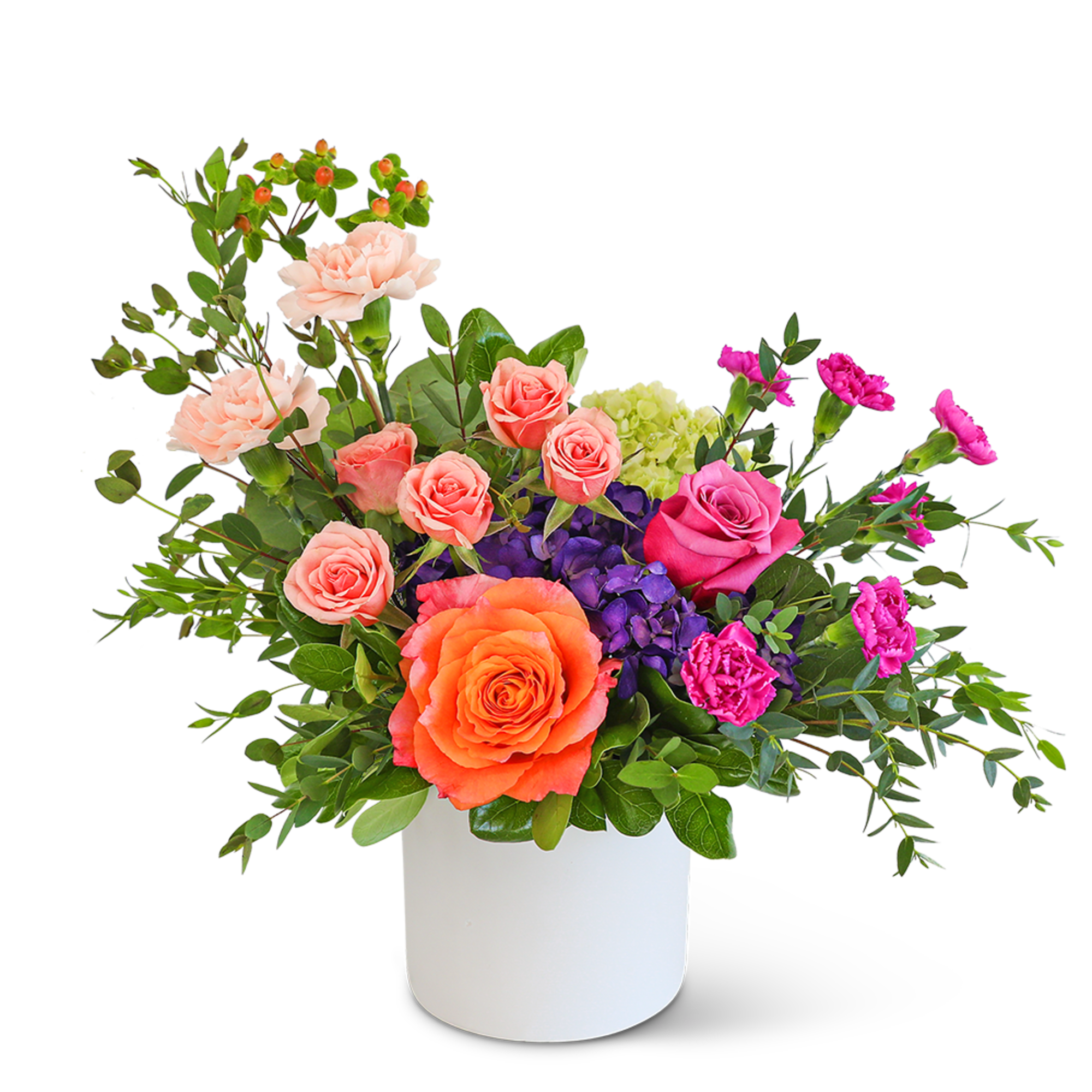 Mixed bouquet of roses, carnations, and hydrangeas in a white vase