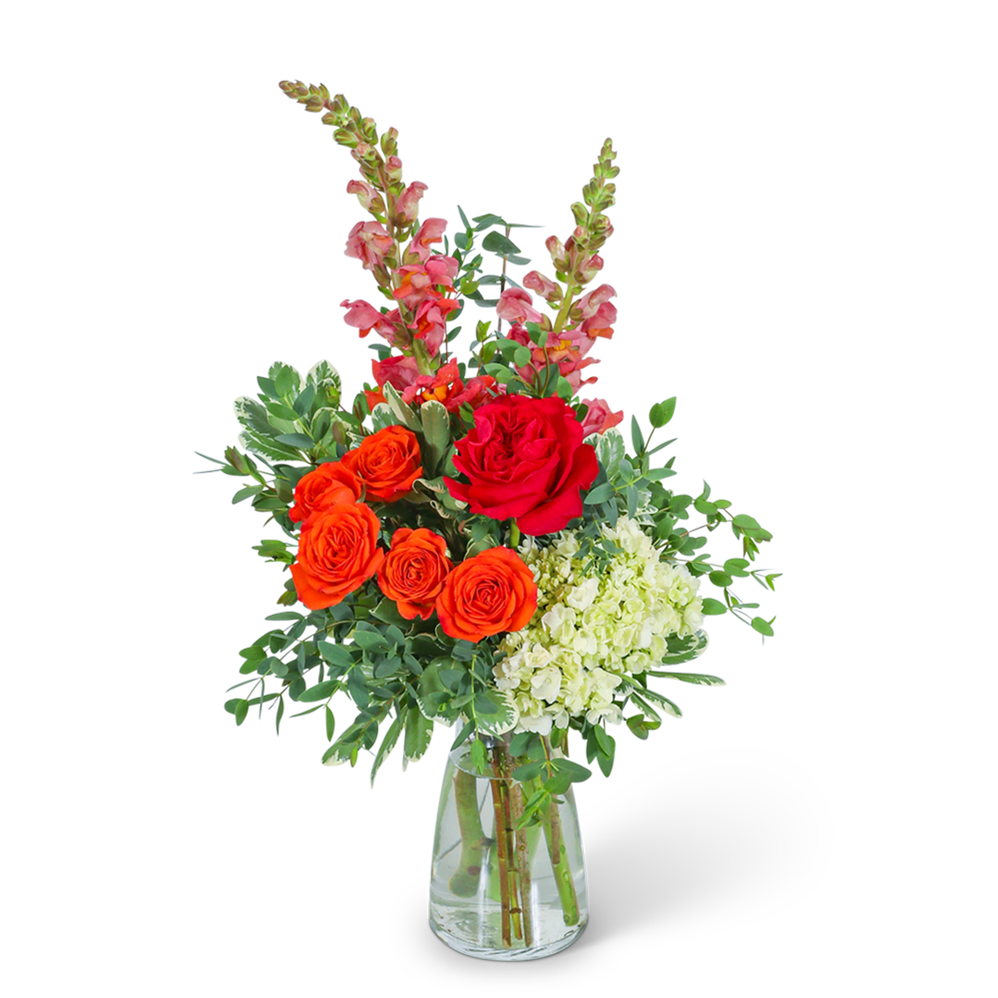 Bouquet of red and orange roses with pink snapdragons in a glass vase