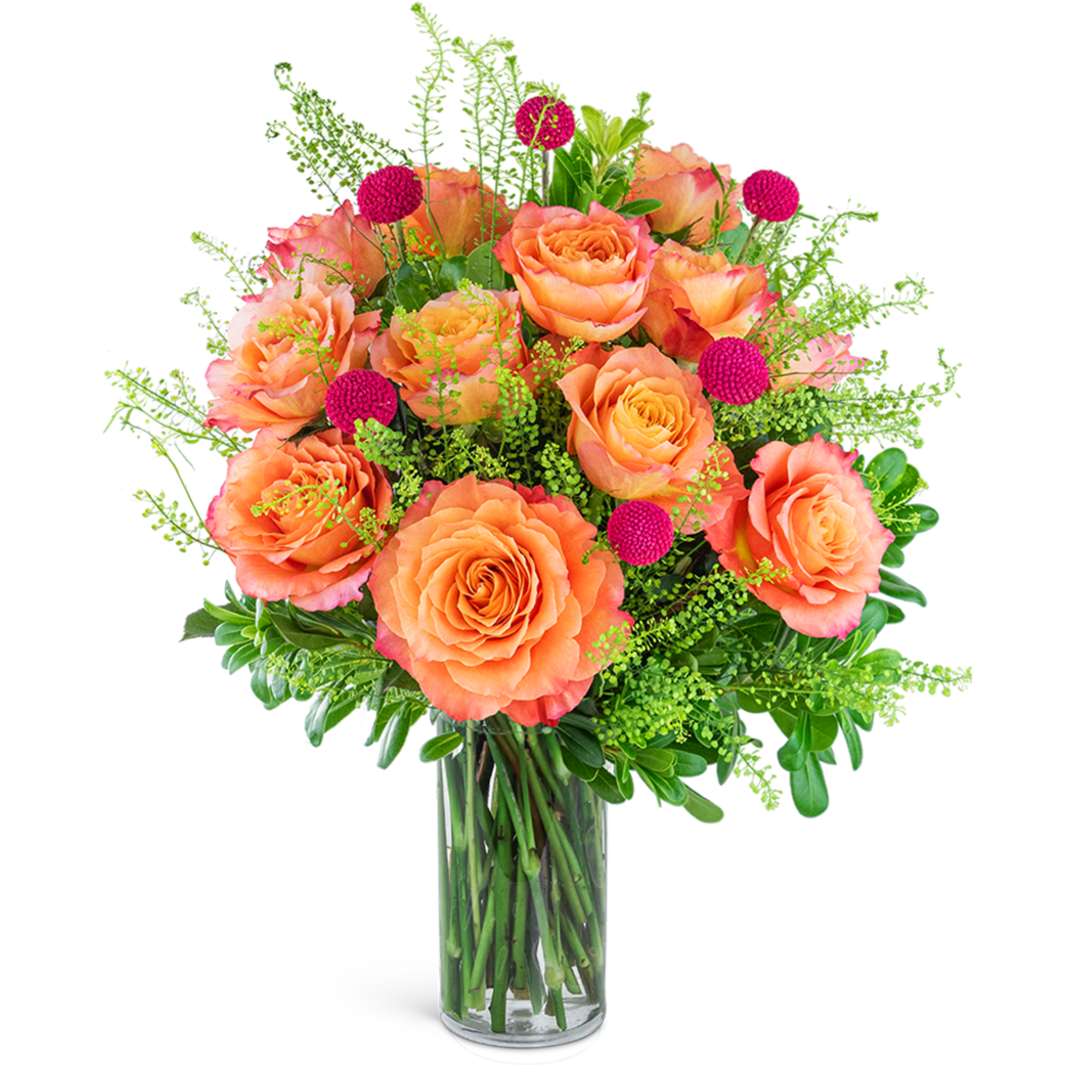 Orange roses in a clear glass vase with pink accent blooms