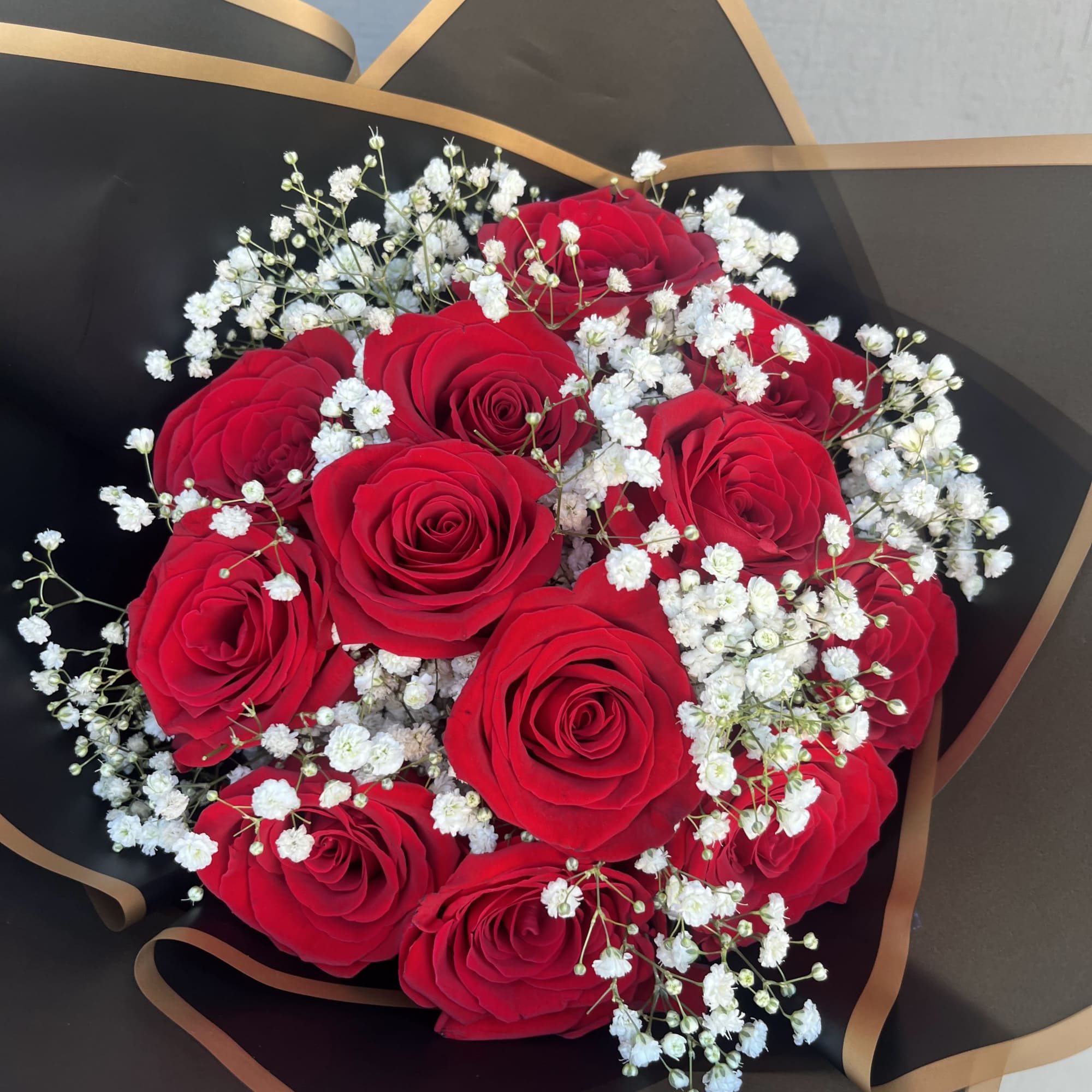 Bouquet of red roses with white baby's breath in black wrap, photo 3 of 3