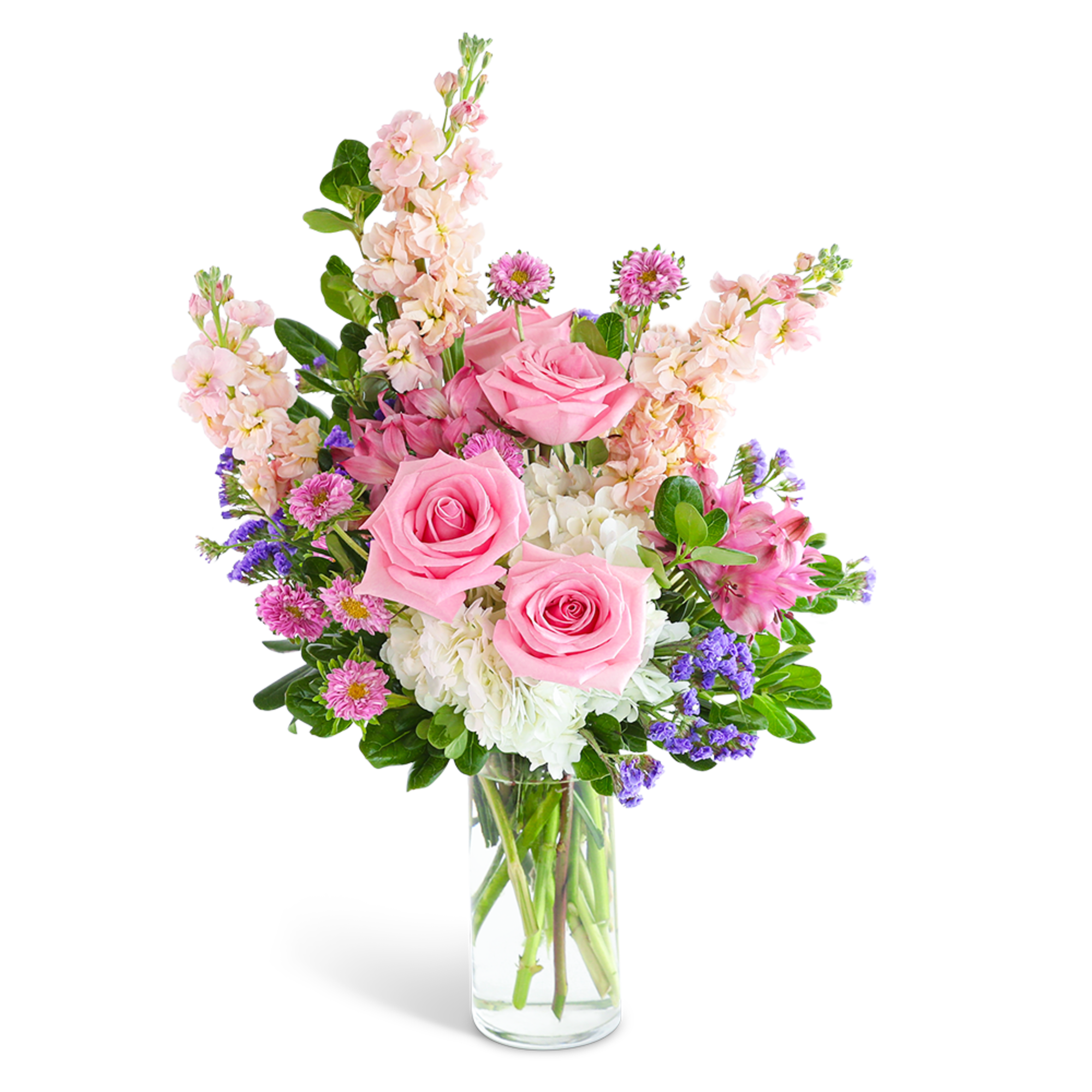 Pink roses and mixed flowers arranged in a clear glass vase