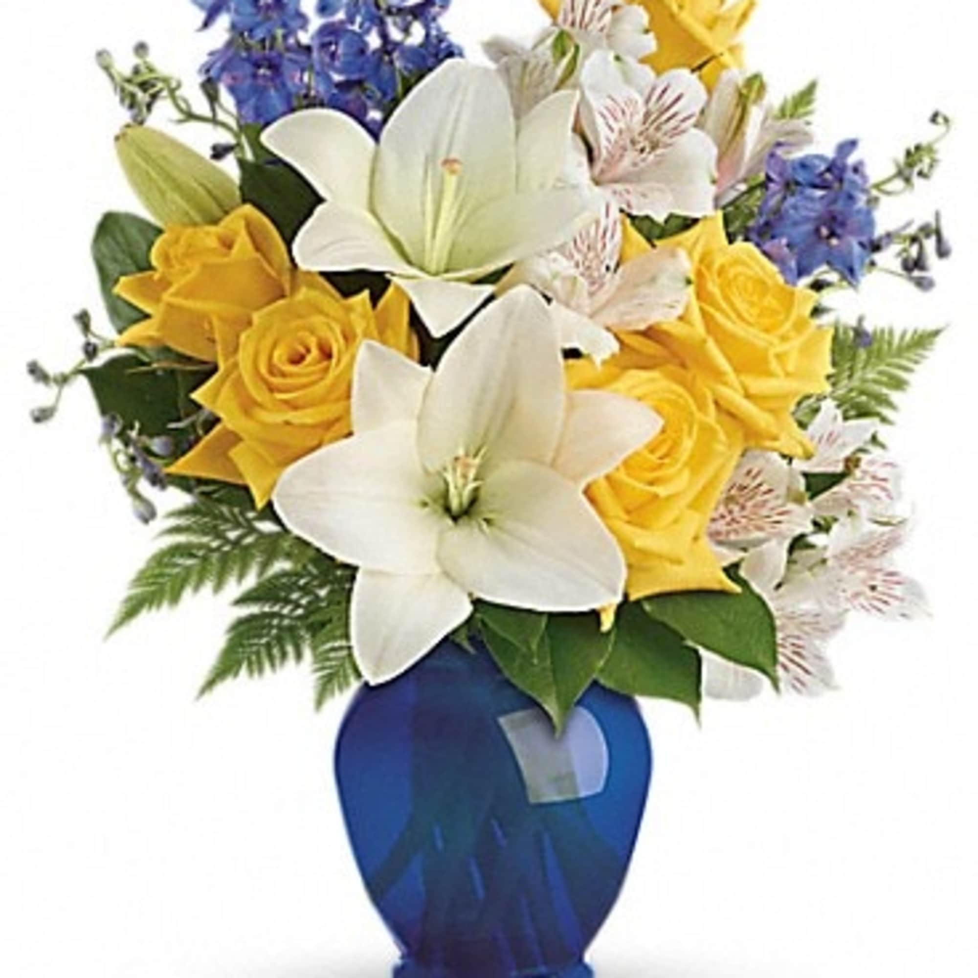 Yellow roses and white lilies in a blue vase