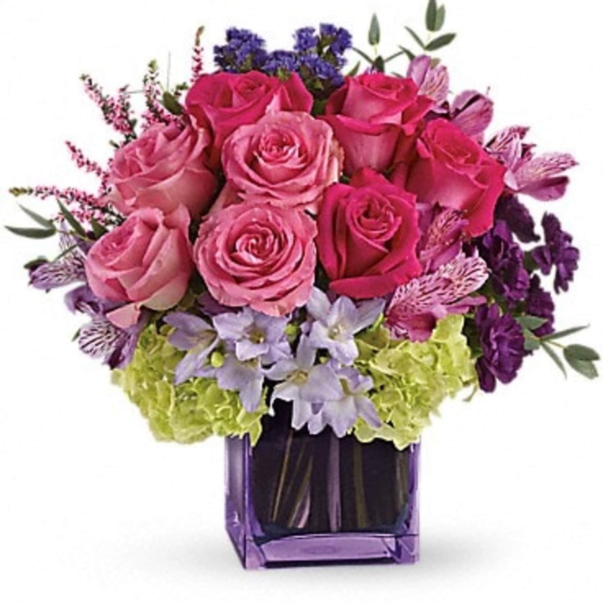 Pink and purple rose bouquet in a purple glass vase