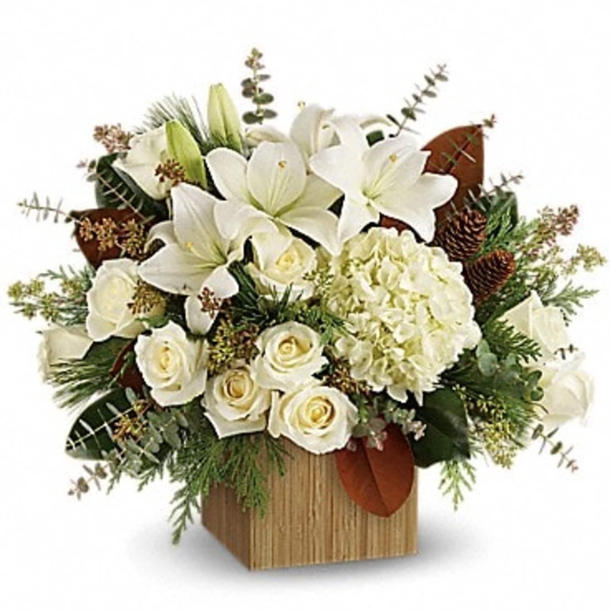 White lilies and roses arranged in a square wooden container