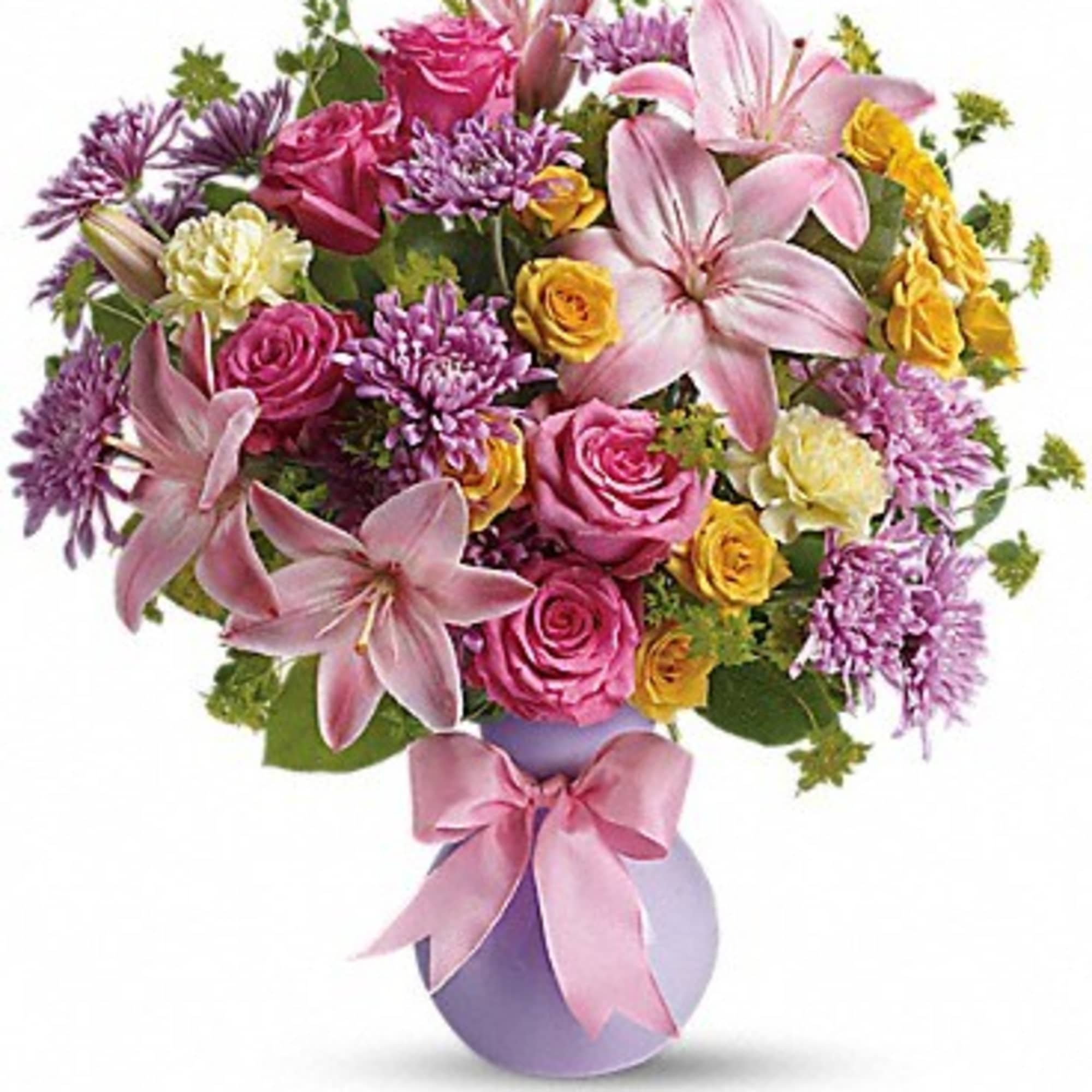 Pink and purple bouquet with lilies and roses in a lavender vase