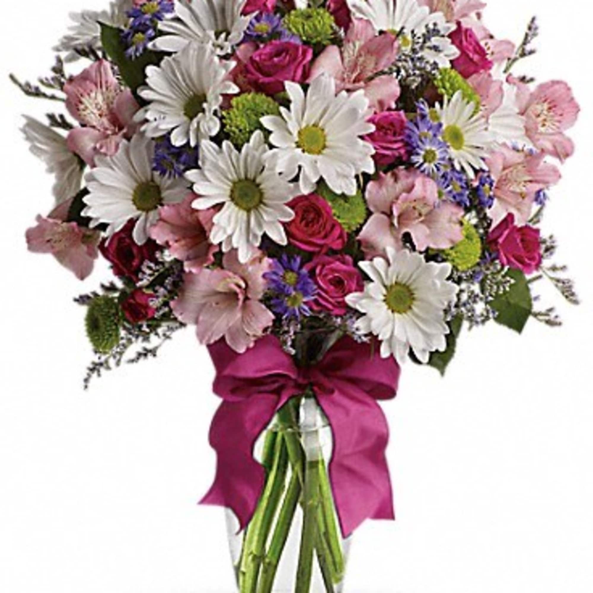 Bouquet of pink and white flowers in a glass vase with a magenta ribbon