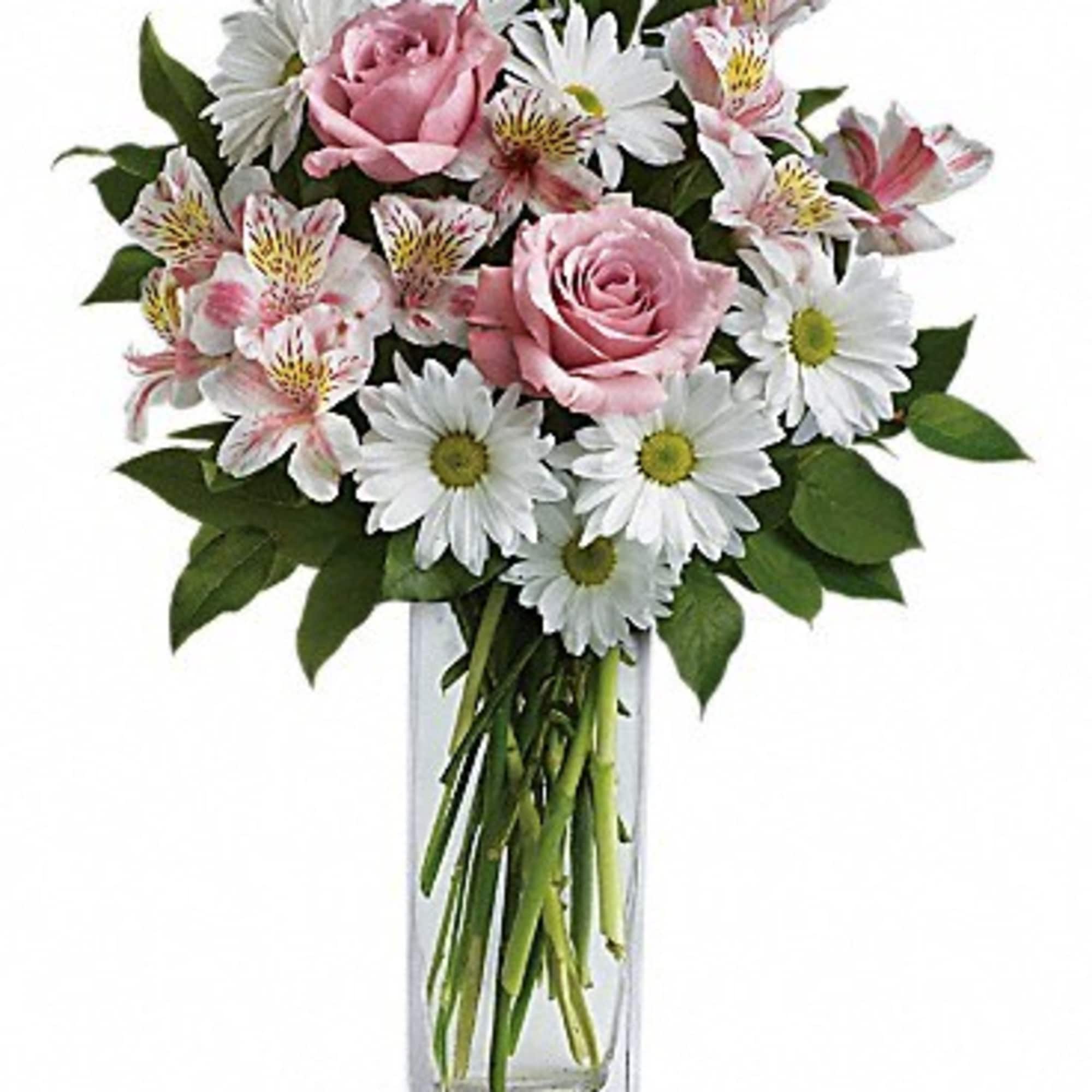 Pink roses and white daisies in a clear glass vase