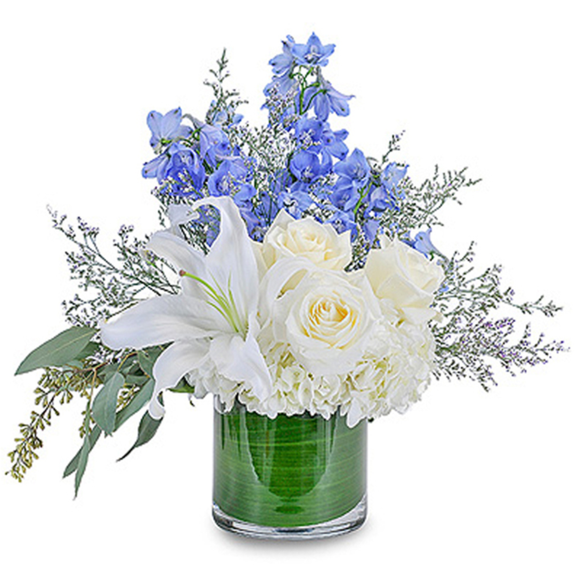 White lilies, roses, and hydrangea with blue delphinium in a clear cylinder vase