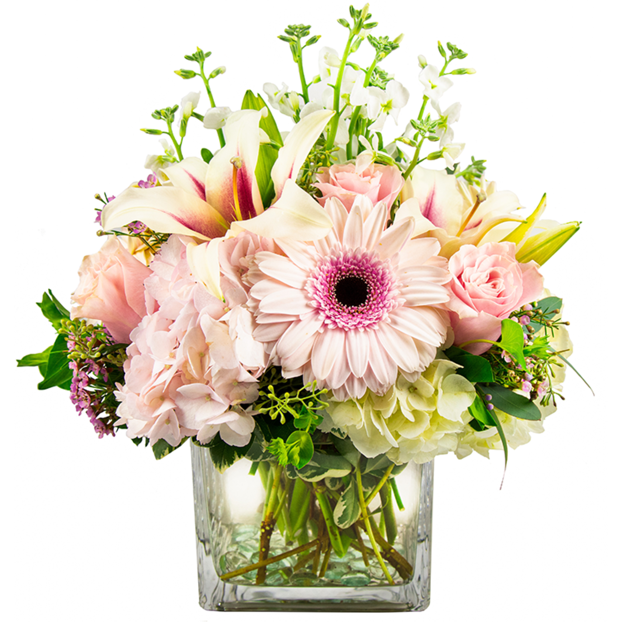 Pink and white flowers arranged in a clear square vase