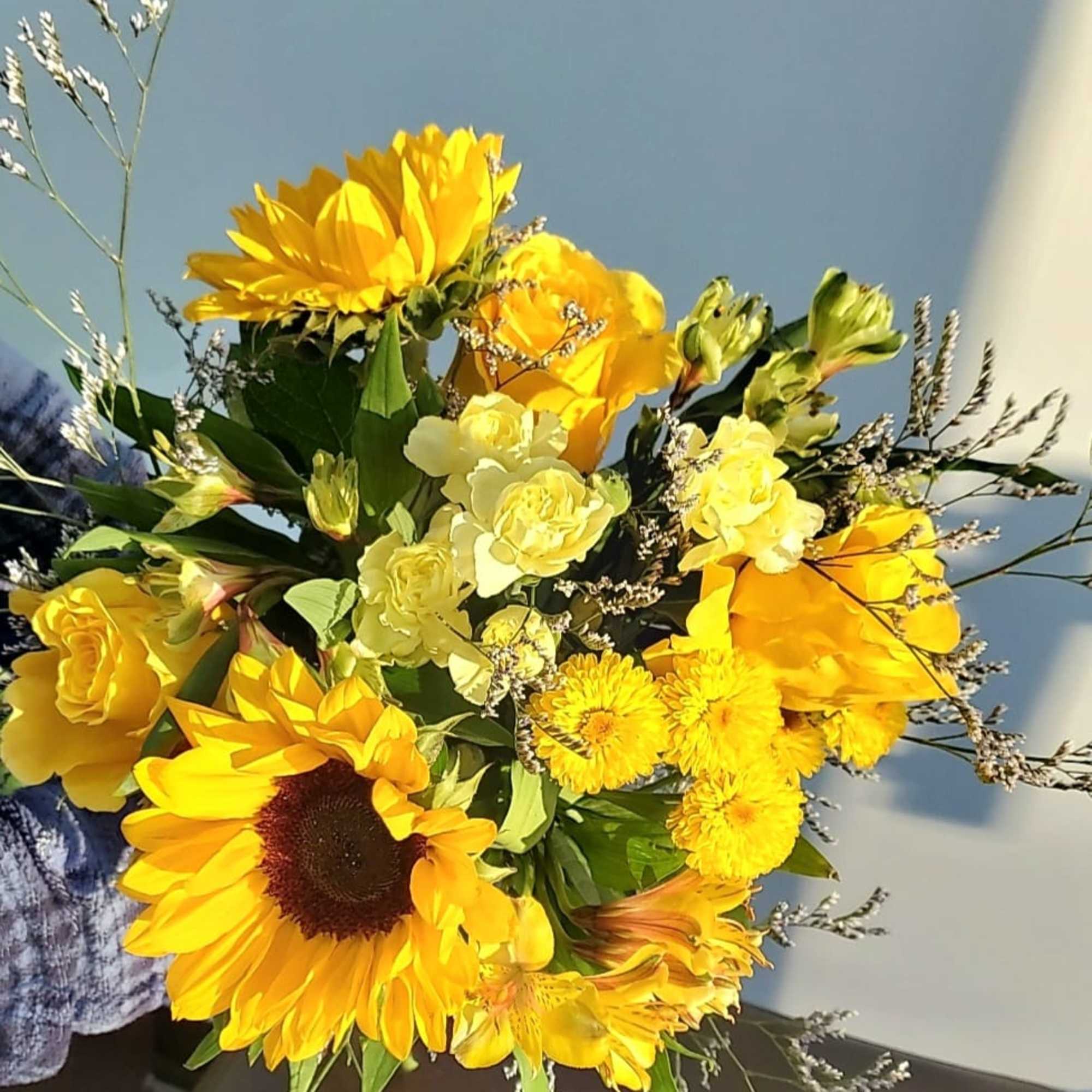 Bouquet of yellow sunflowers and mixed yellow flowers