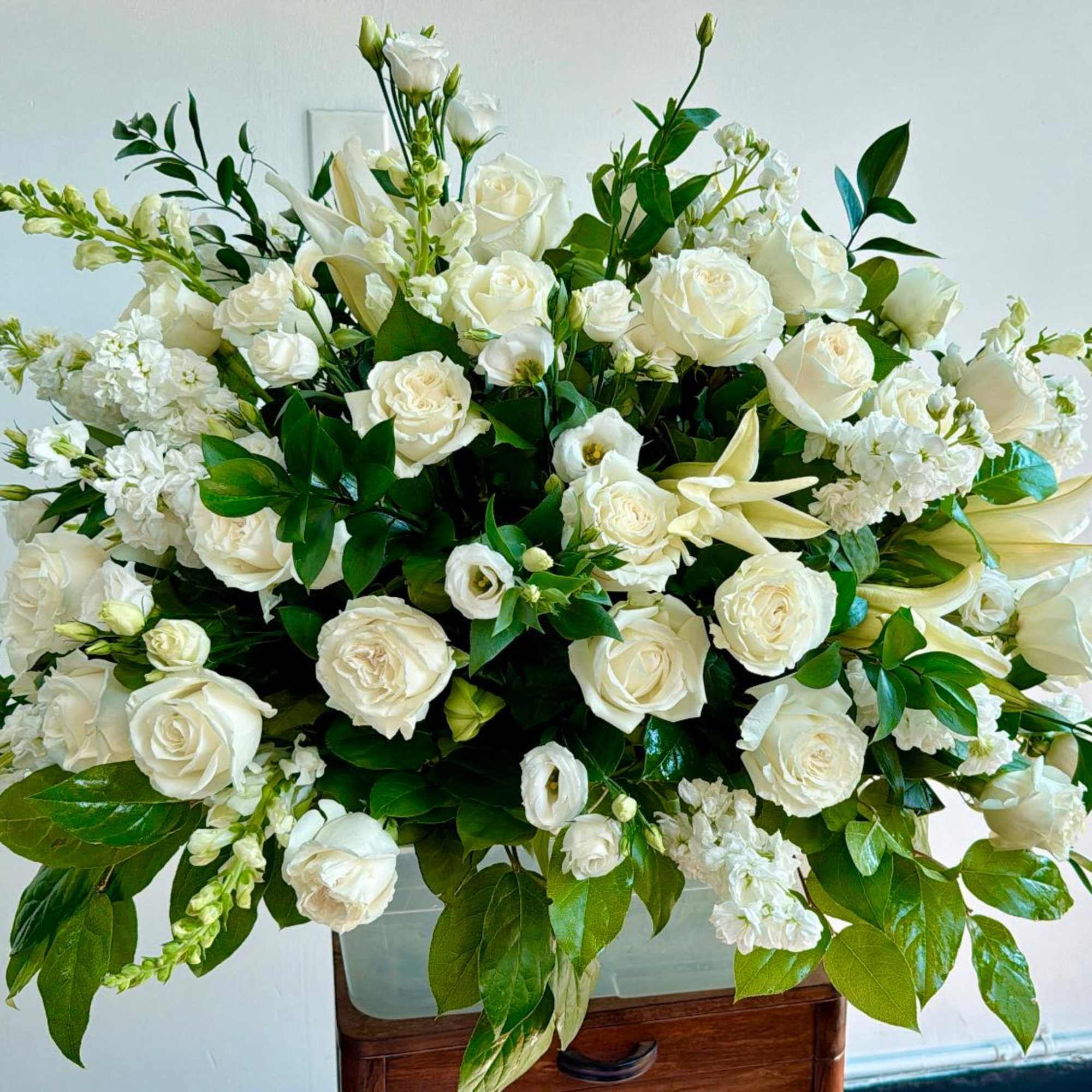 An all white tribute, this half casket spray is pure in color, photo 2 of 3