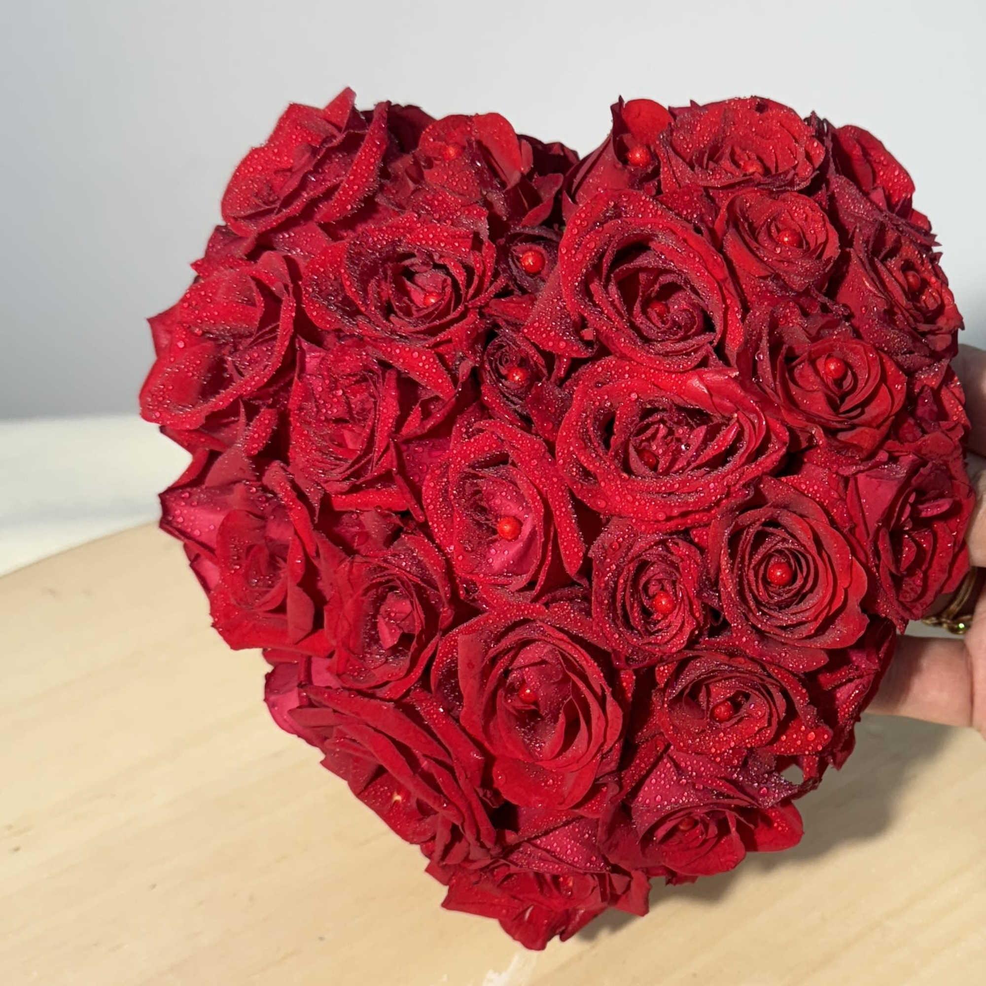 Heart-shaped bouquet of red roses