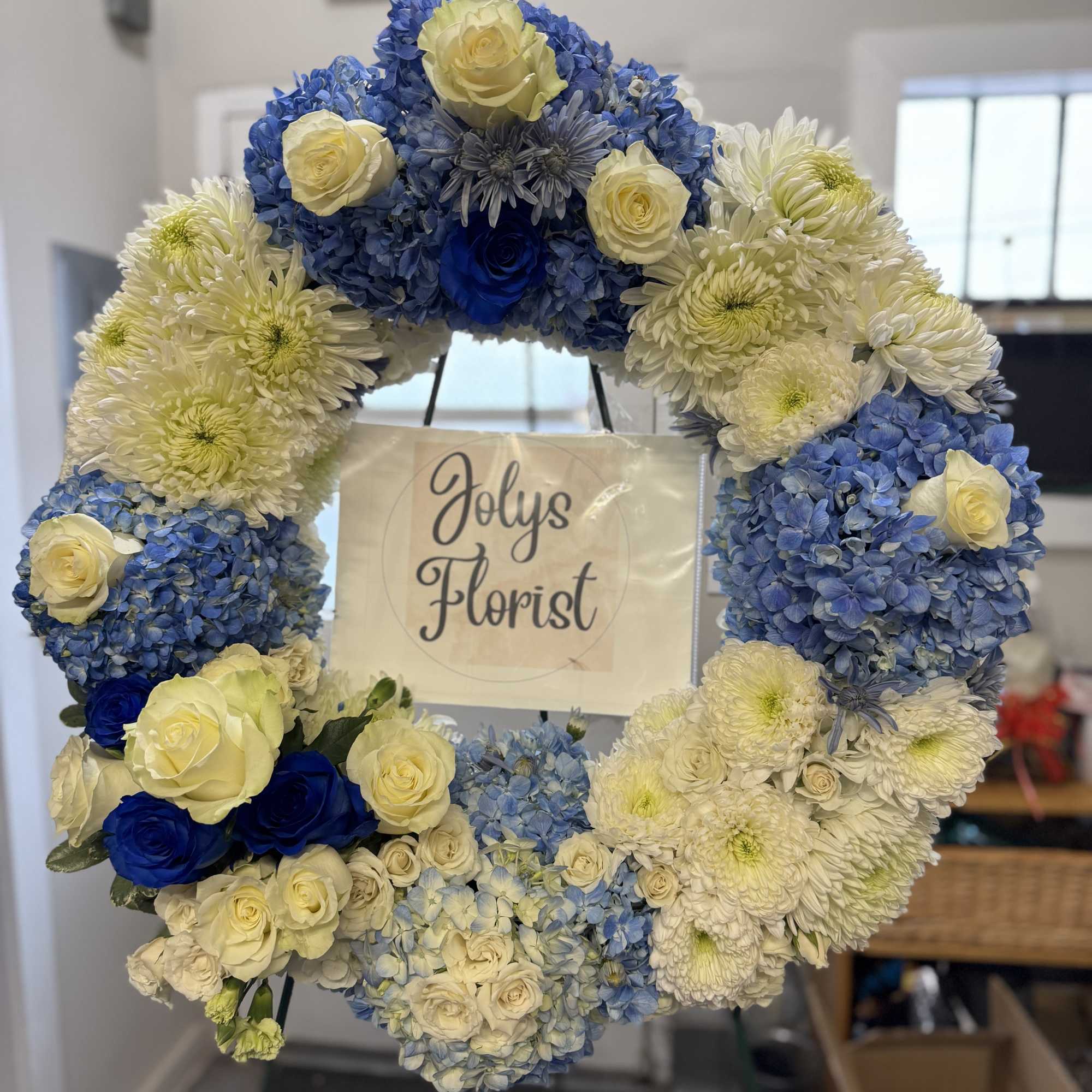 Blue and white floral wreath with roses and chrysanthemums