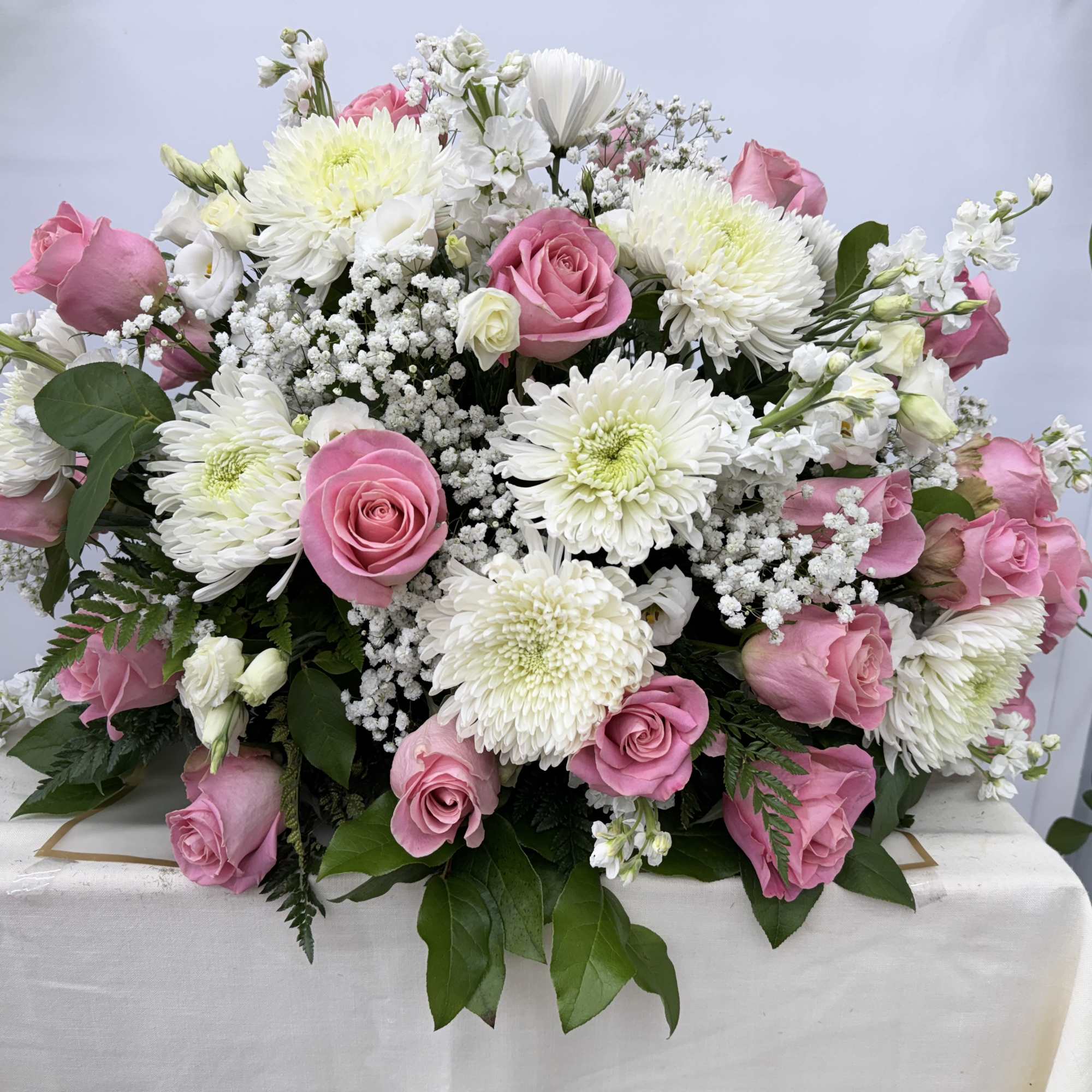 Pink roses and white chrysanthemums arranged in a low bouquet, photo 2 of 2