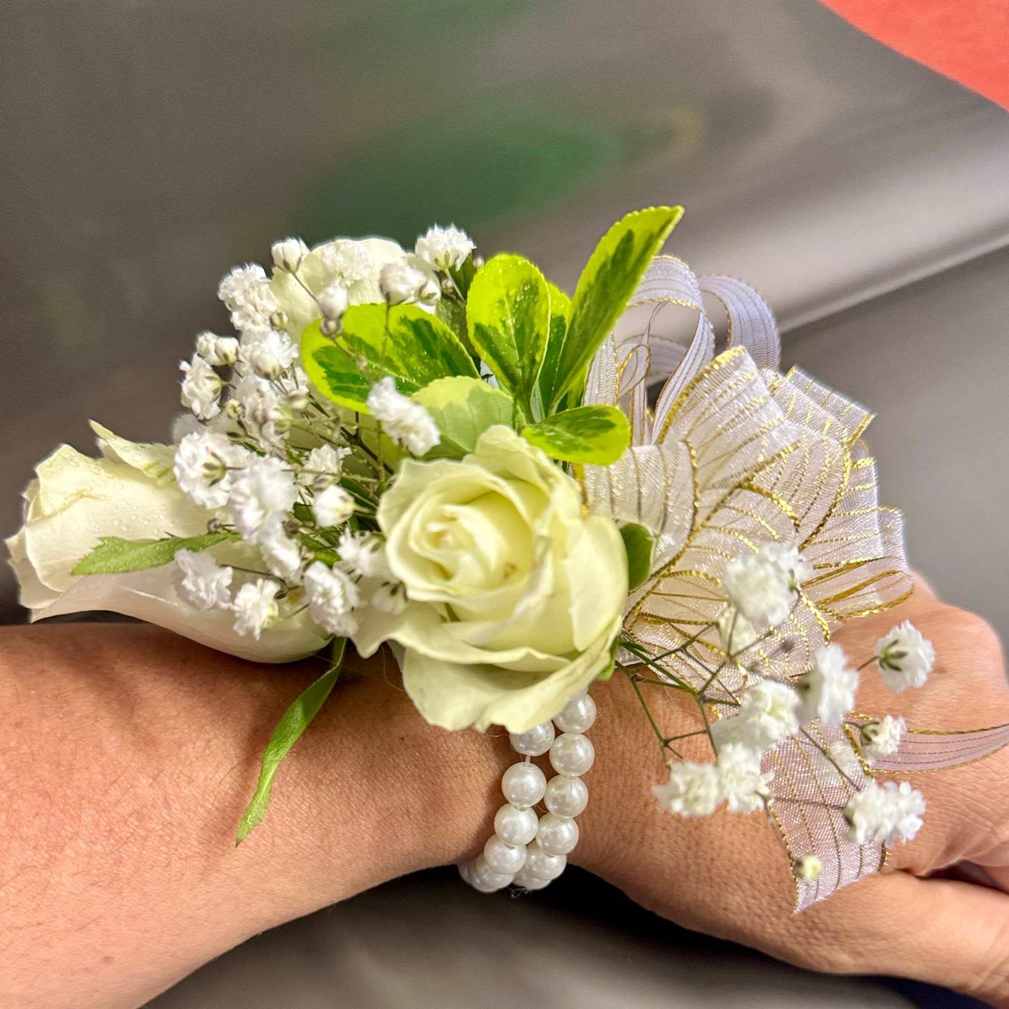 White rose wrist corsage with baby's breath and pearl bracelet