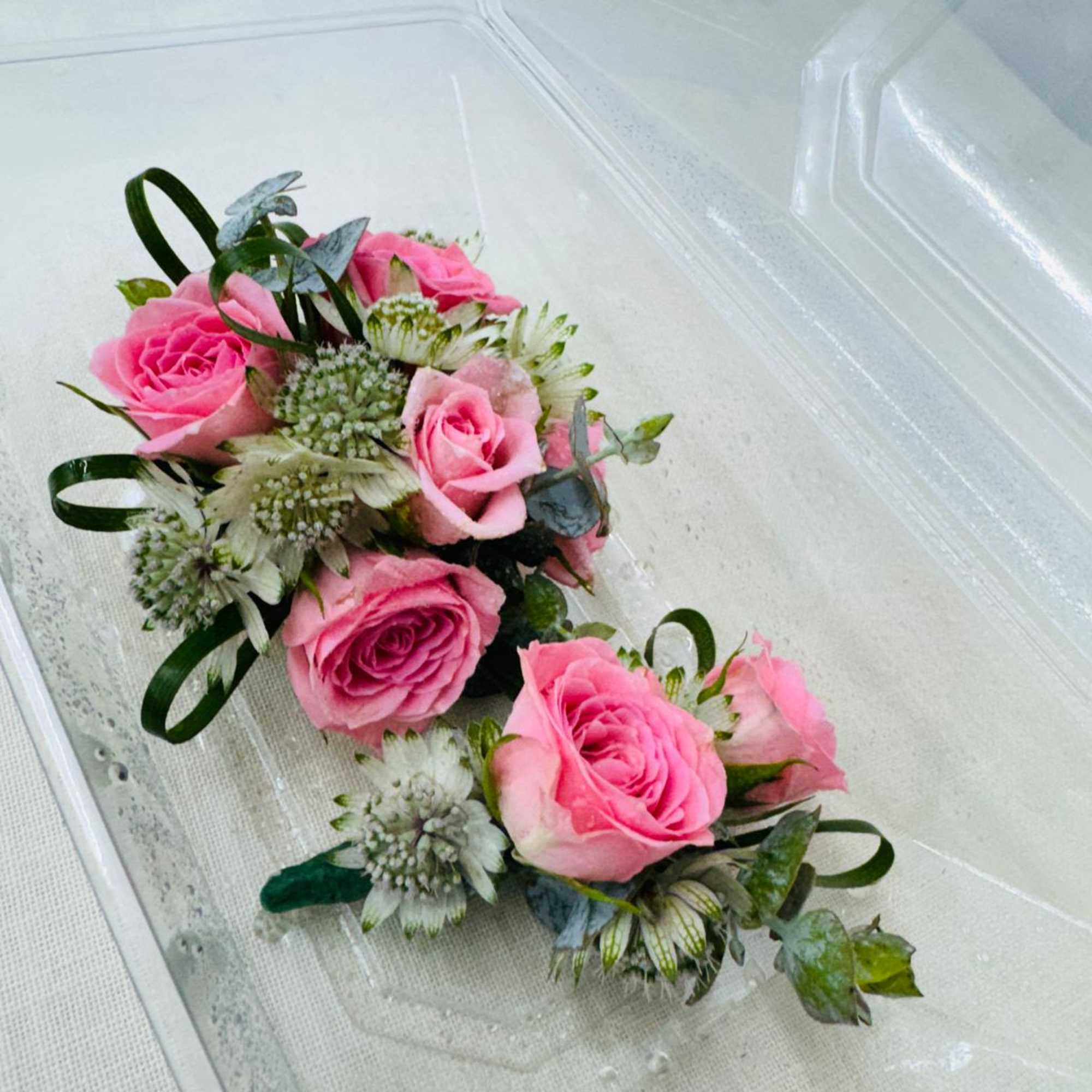 A classic  pink rose and baby's breath corsage compliments any outfit., photo 2 of 3