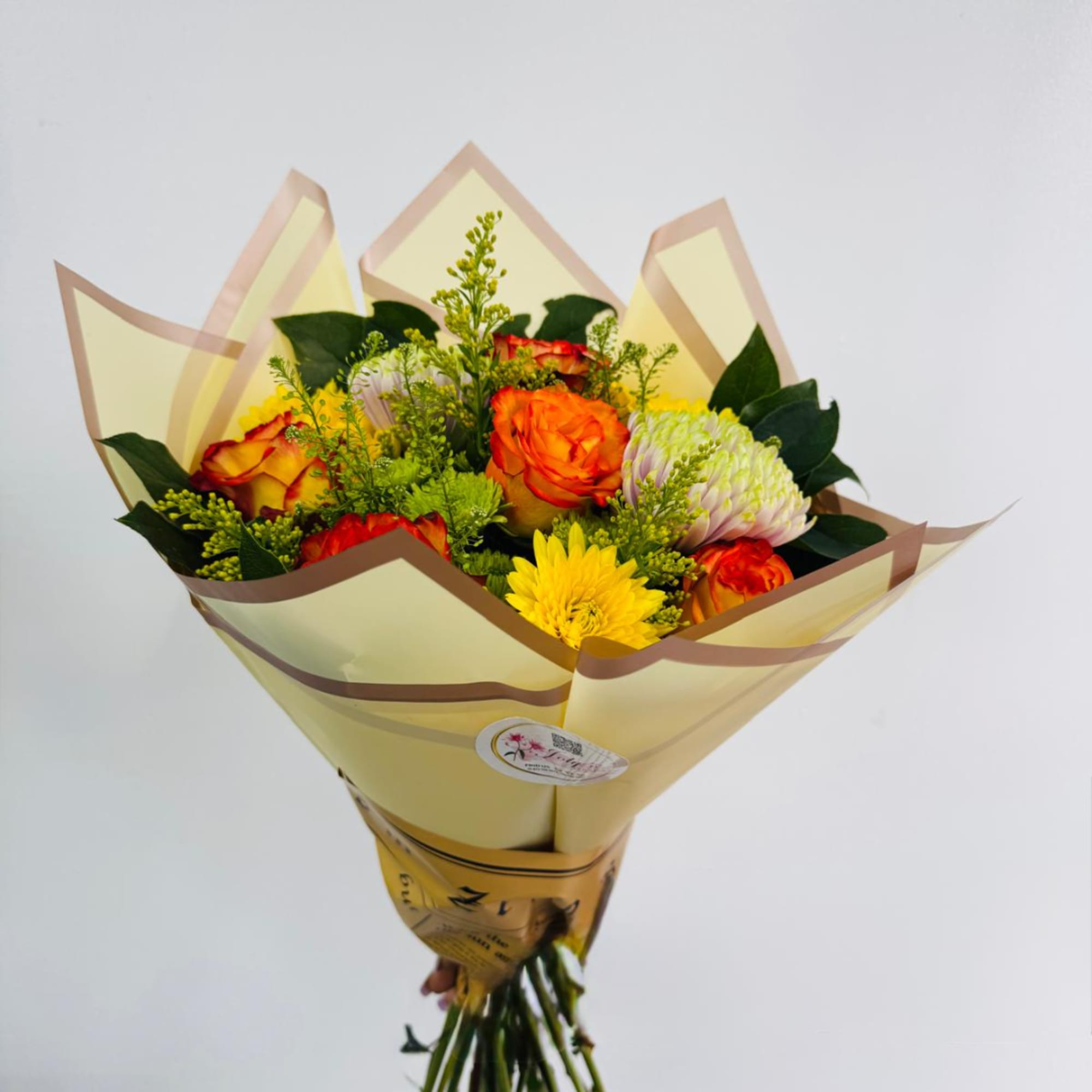 Bouquet of orange and yellow flowers wrapped in pale paper, photo 2 of 4