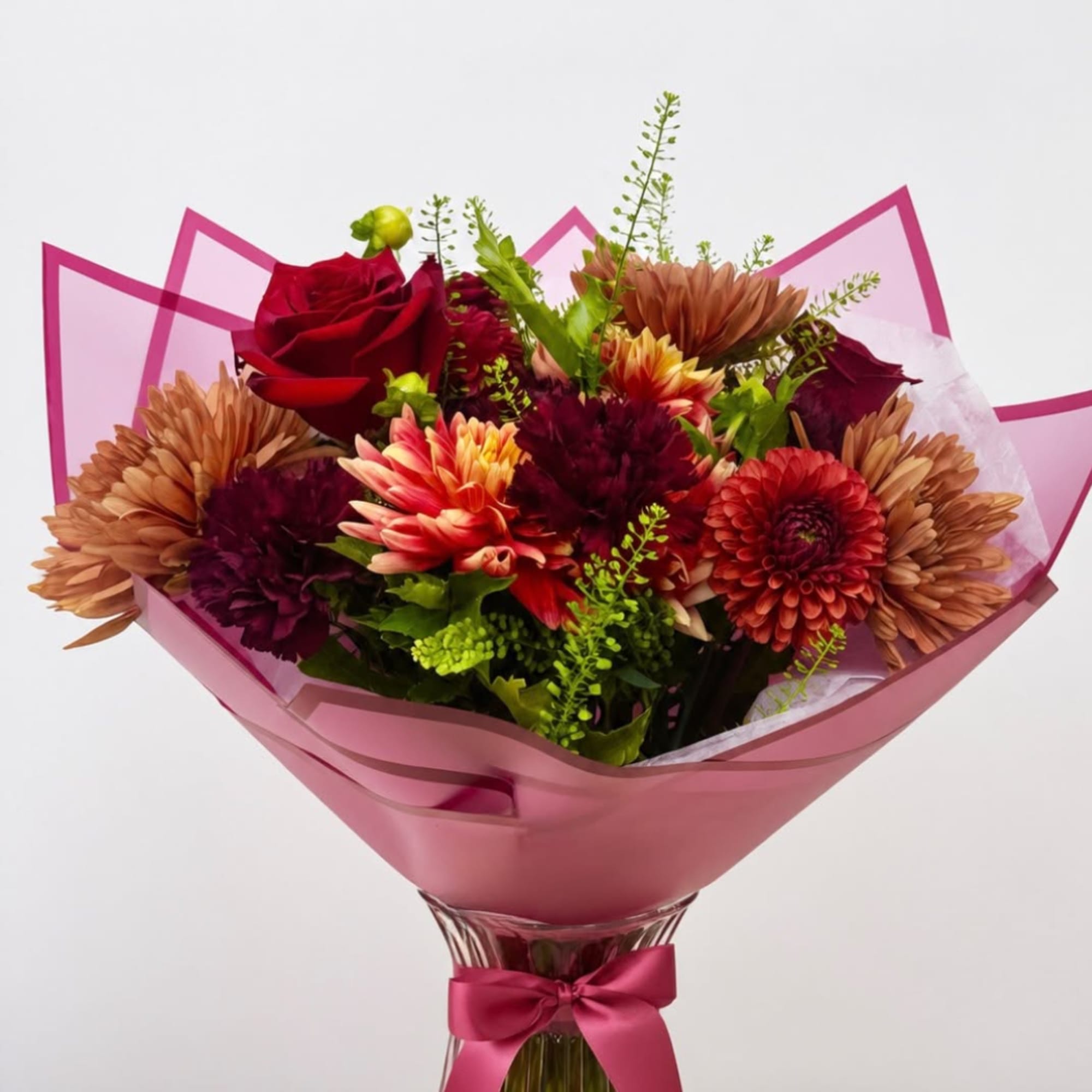 Bouquet of red roses and mixed chrysanthemums wrapped in pink paper