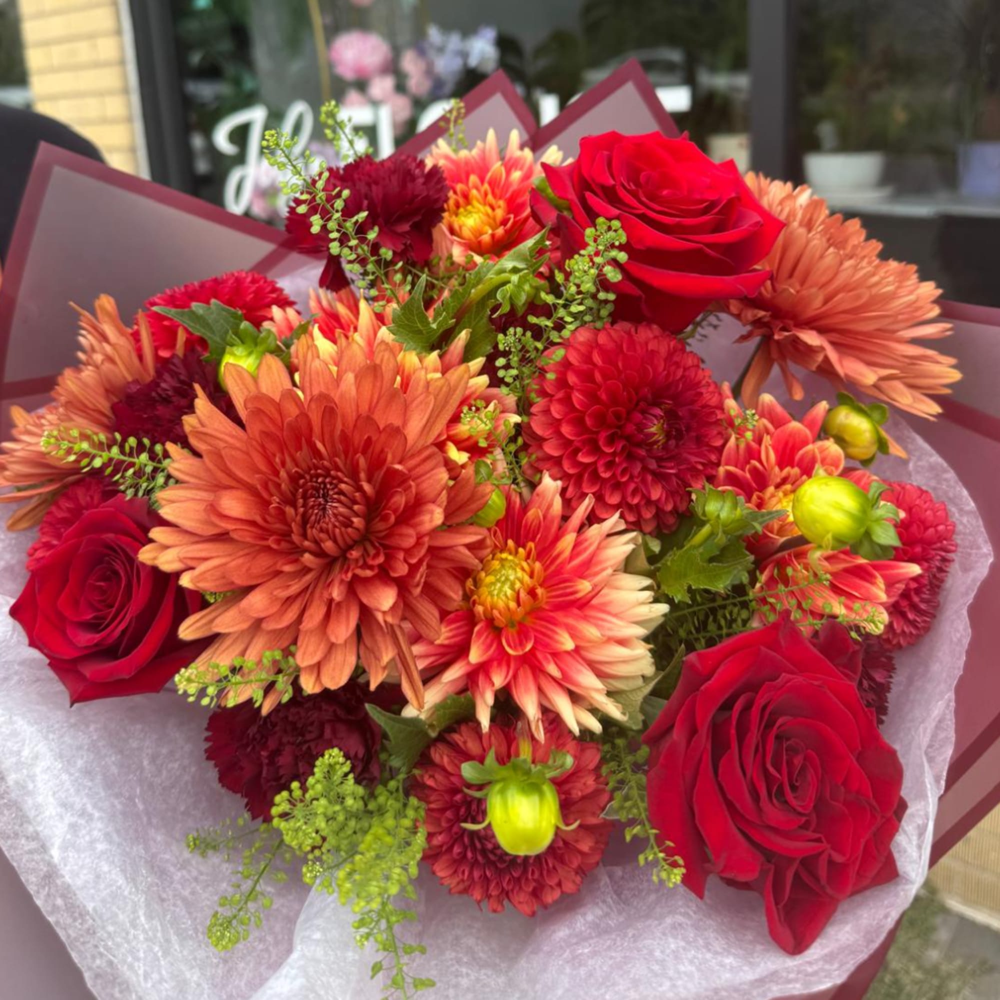 Bouquet of red roses and orange chrysanthemums wrapped in burgundy paper, photo 3 of 4