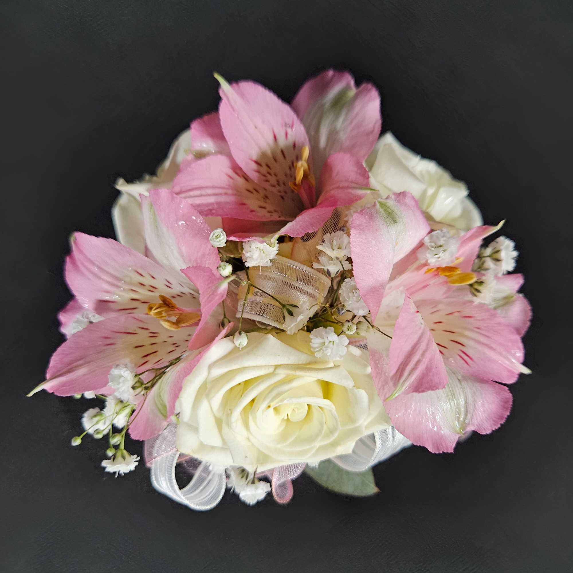 Pink alstroemeria and white roses in a small bouquet