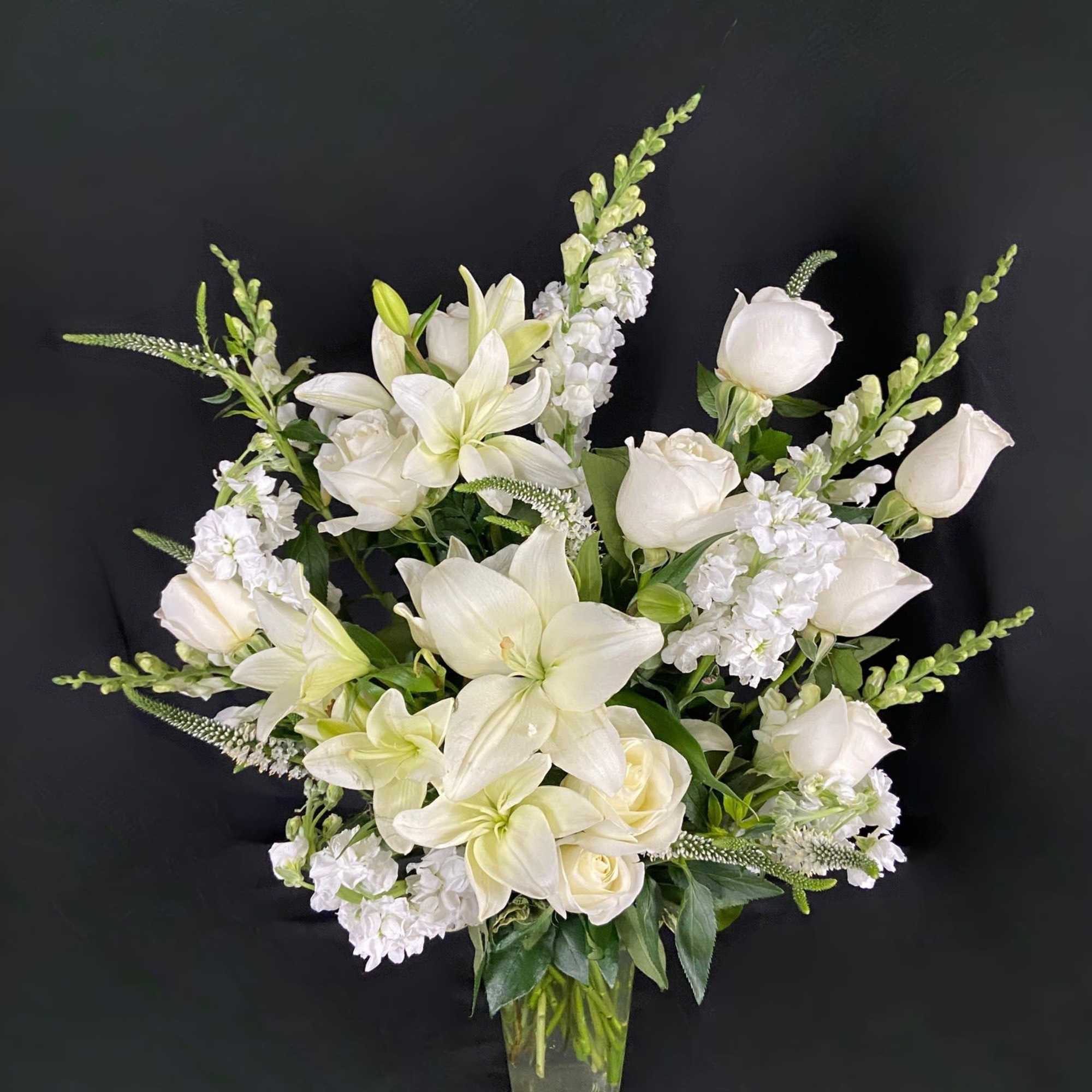 This classy arrangement is full of grace. Featuring an elegant bundle of