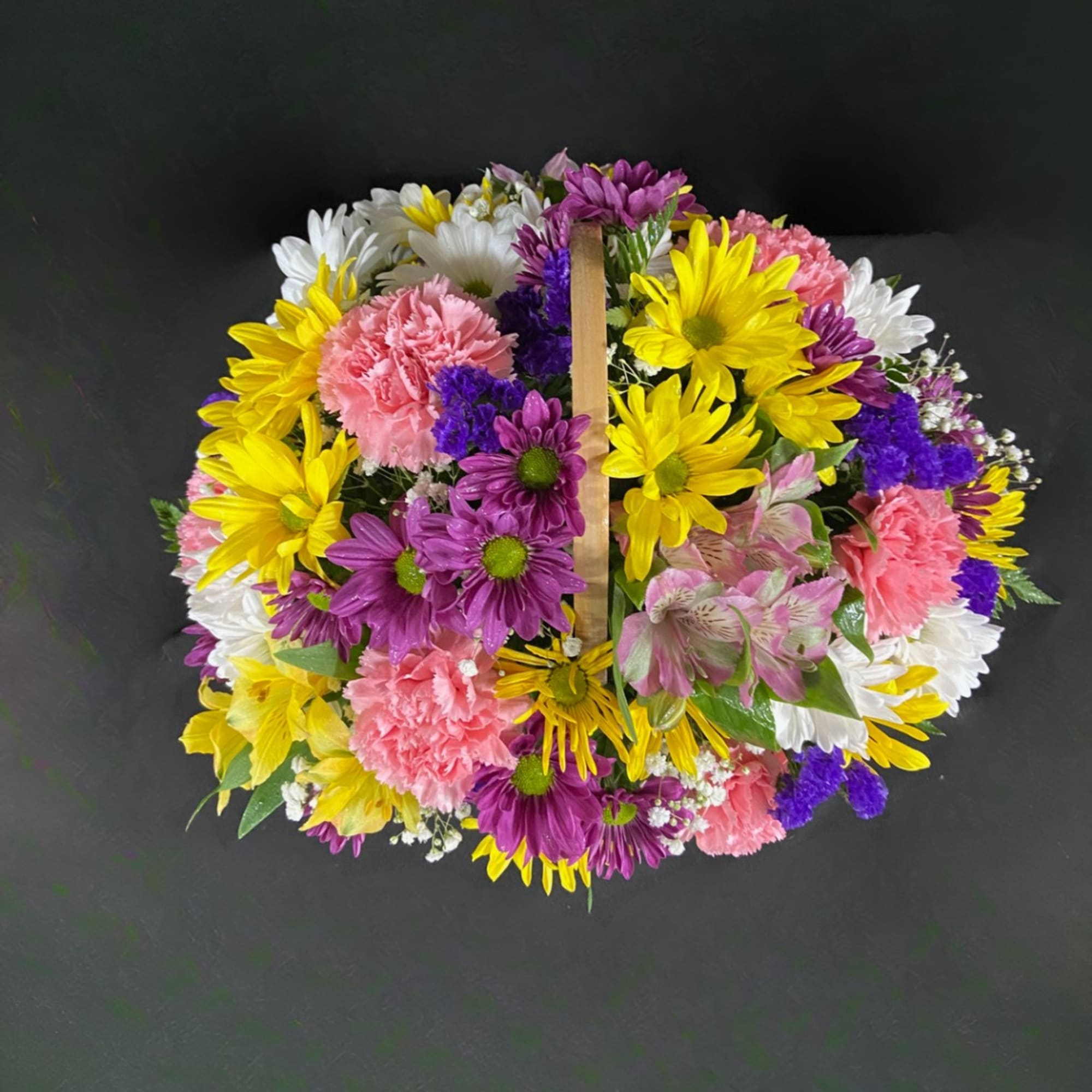 Round bouquet of daisies, carnations, and alstroemeria in bright mixed colors