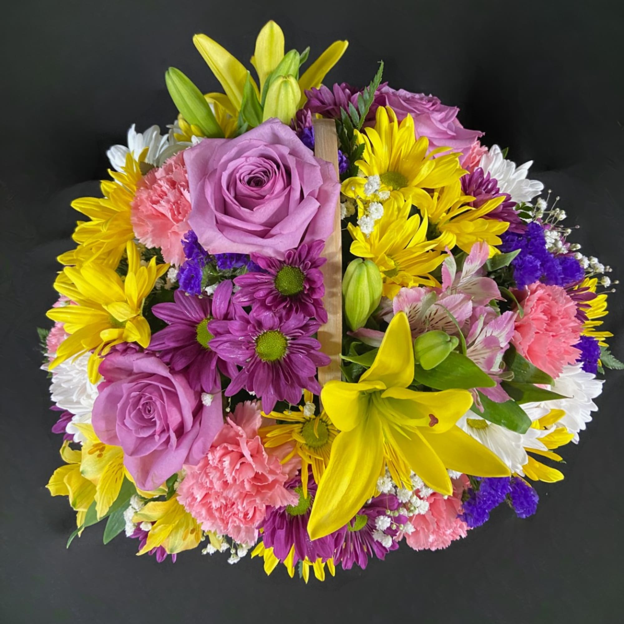 Mixed bouquet with lavender roses, yellow lilies, and purple daisies