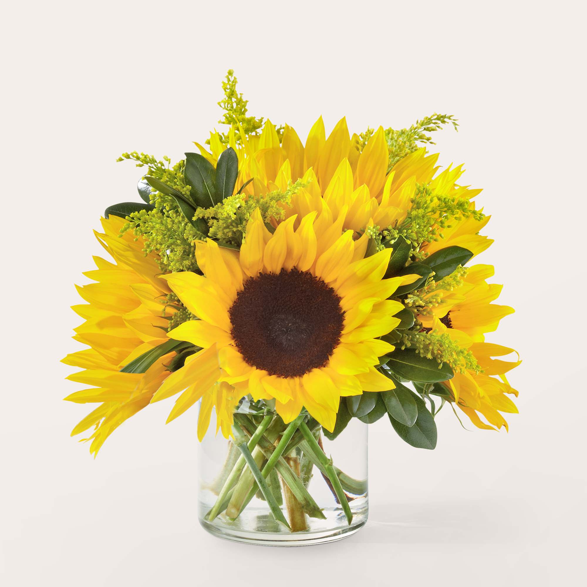 Bouquet of yellow sunflowers in a clear glass vase