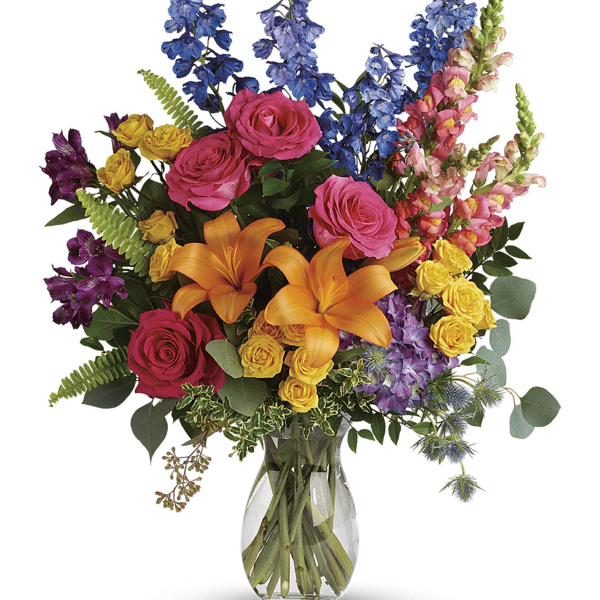 Colorful bouquet of roses, lilies, and mixed blooms in a glass vase