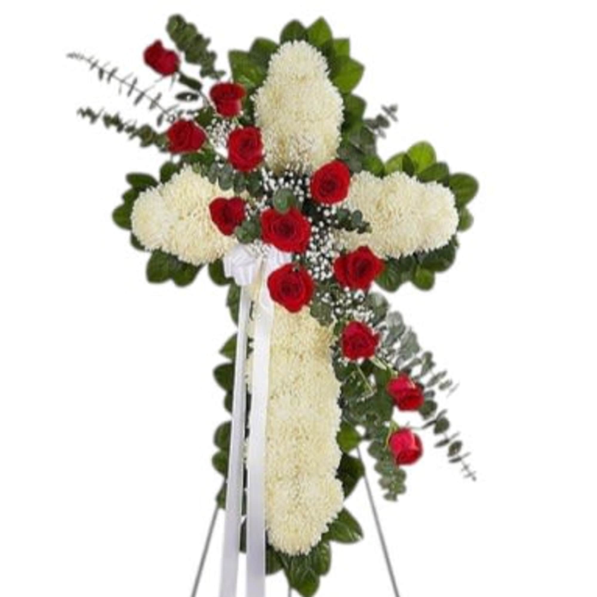 Standing floral cross with red roses and white mums on an easel