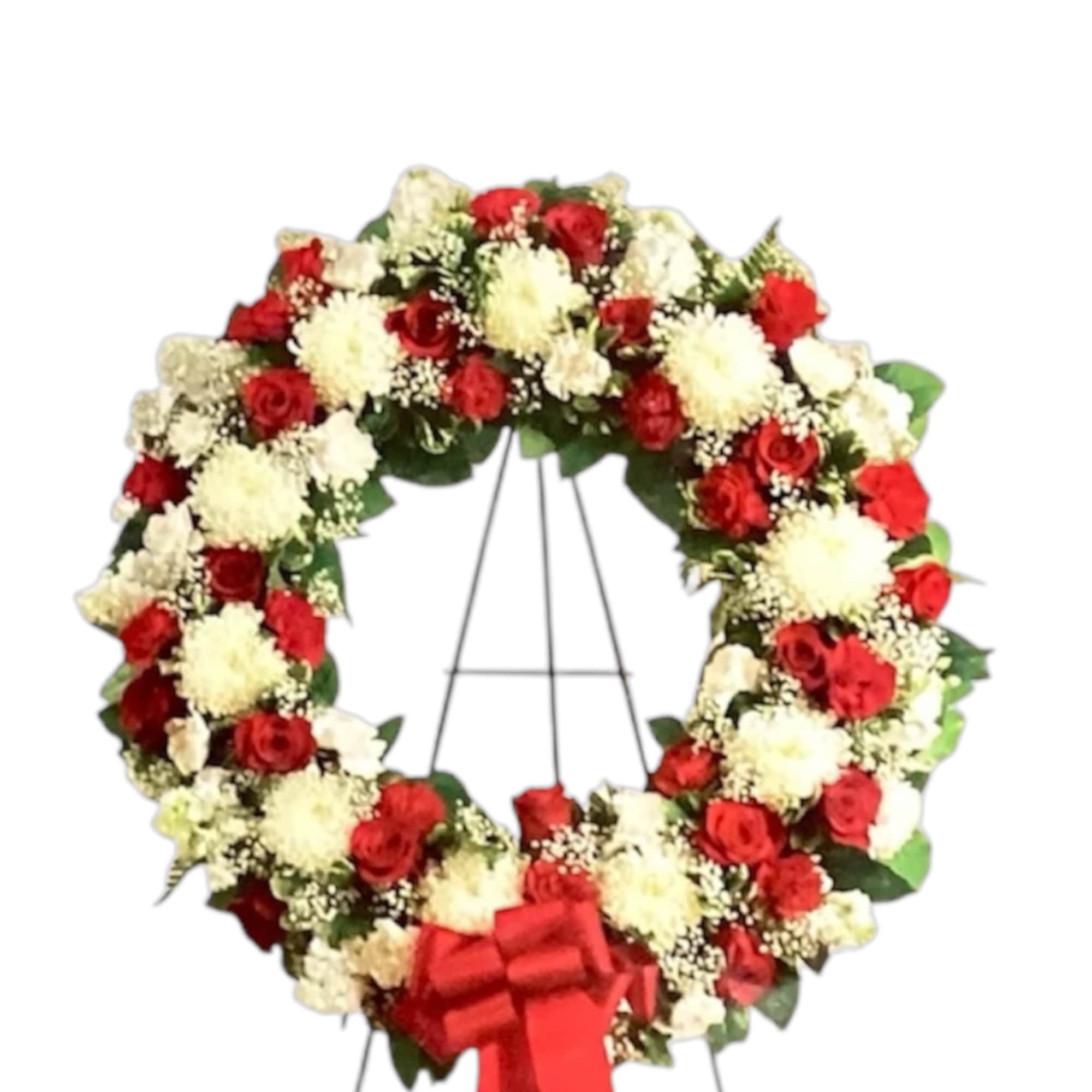 Red and white floral wreath on a stand with a red bow