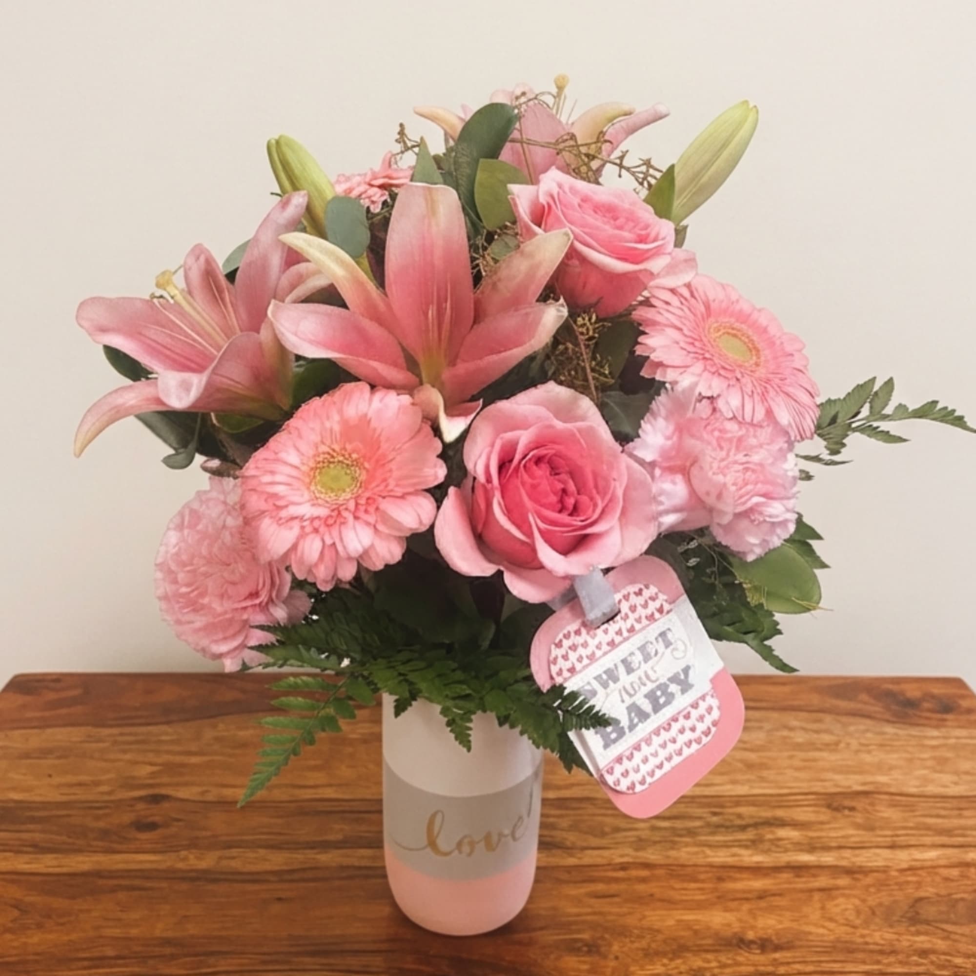 Pink bouquet with lilies, roses, and gerbera daisies in a vase