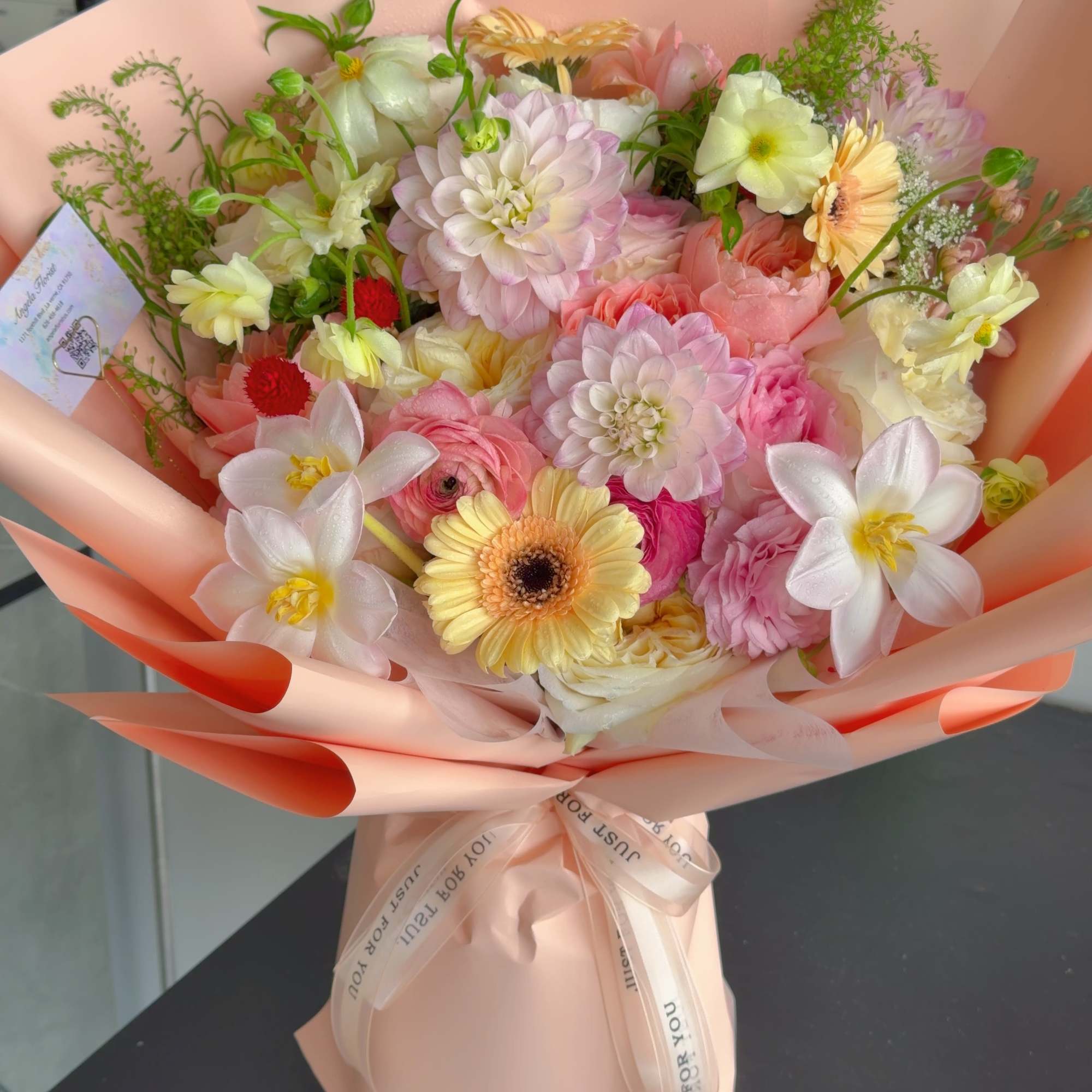 A lush, garden-inspired bouquet featuring a beautiful seasonal selection of garden roses